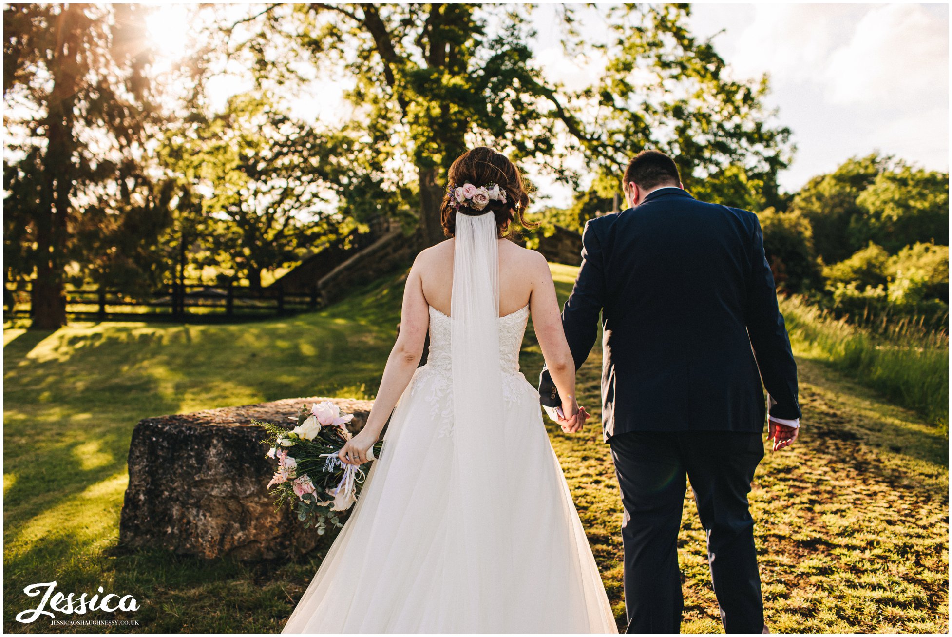 bride walks away with flowers in her hair