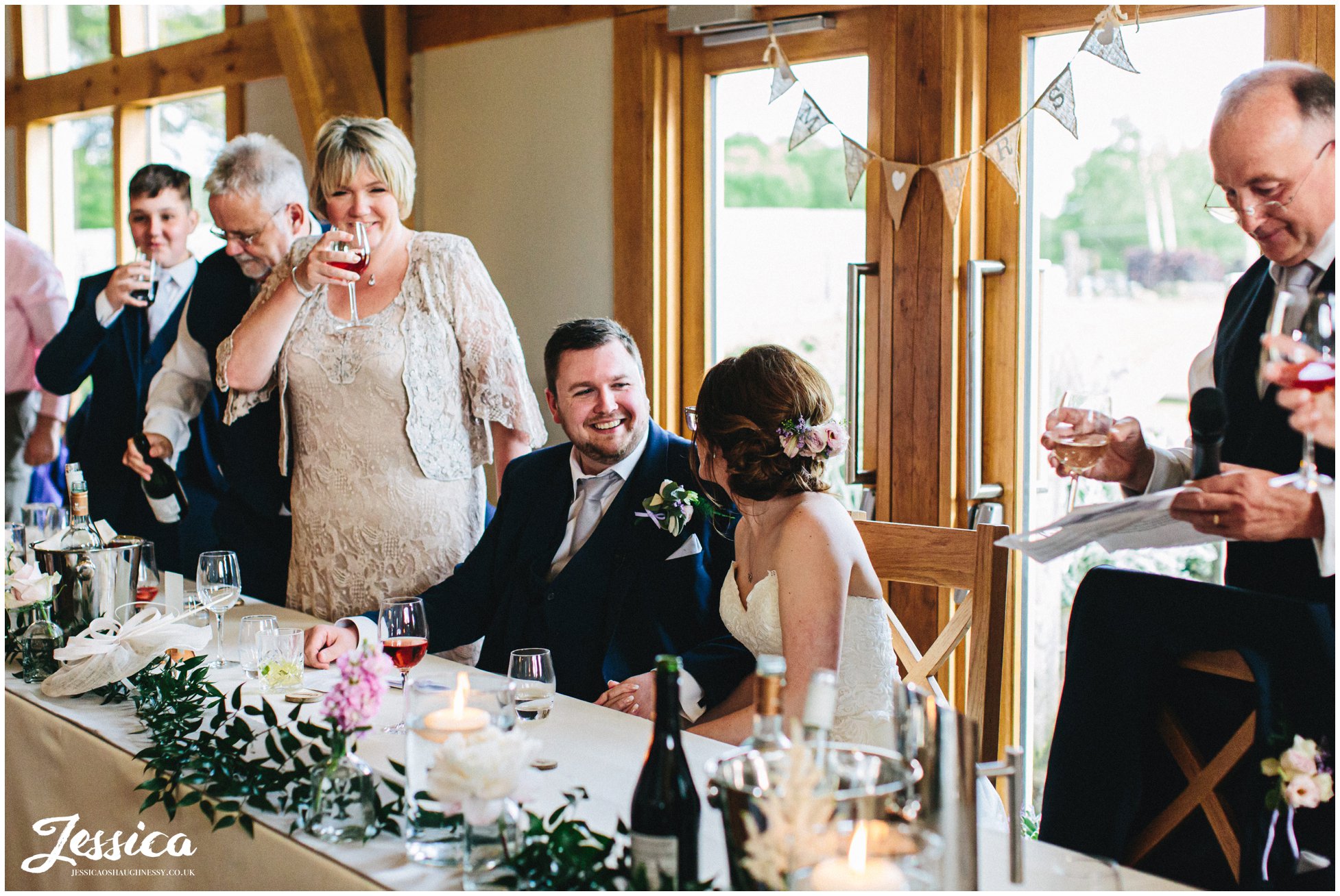 top table stands to toast the newly wed's