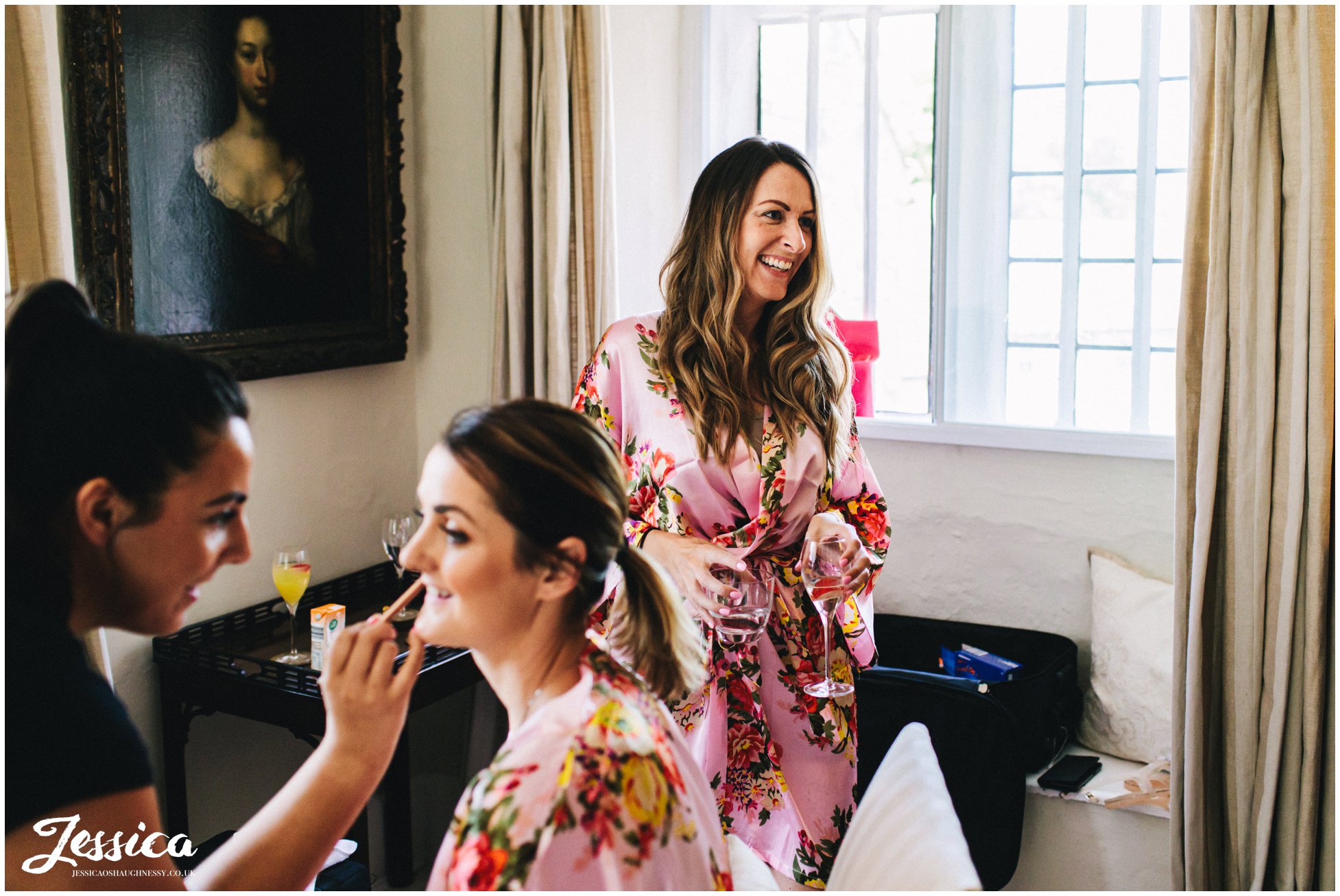 bridesmaids get ready with the bride on the morning of the wedding