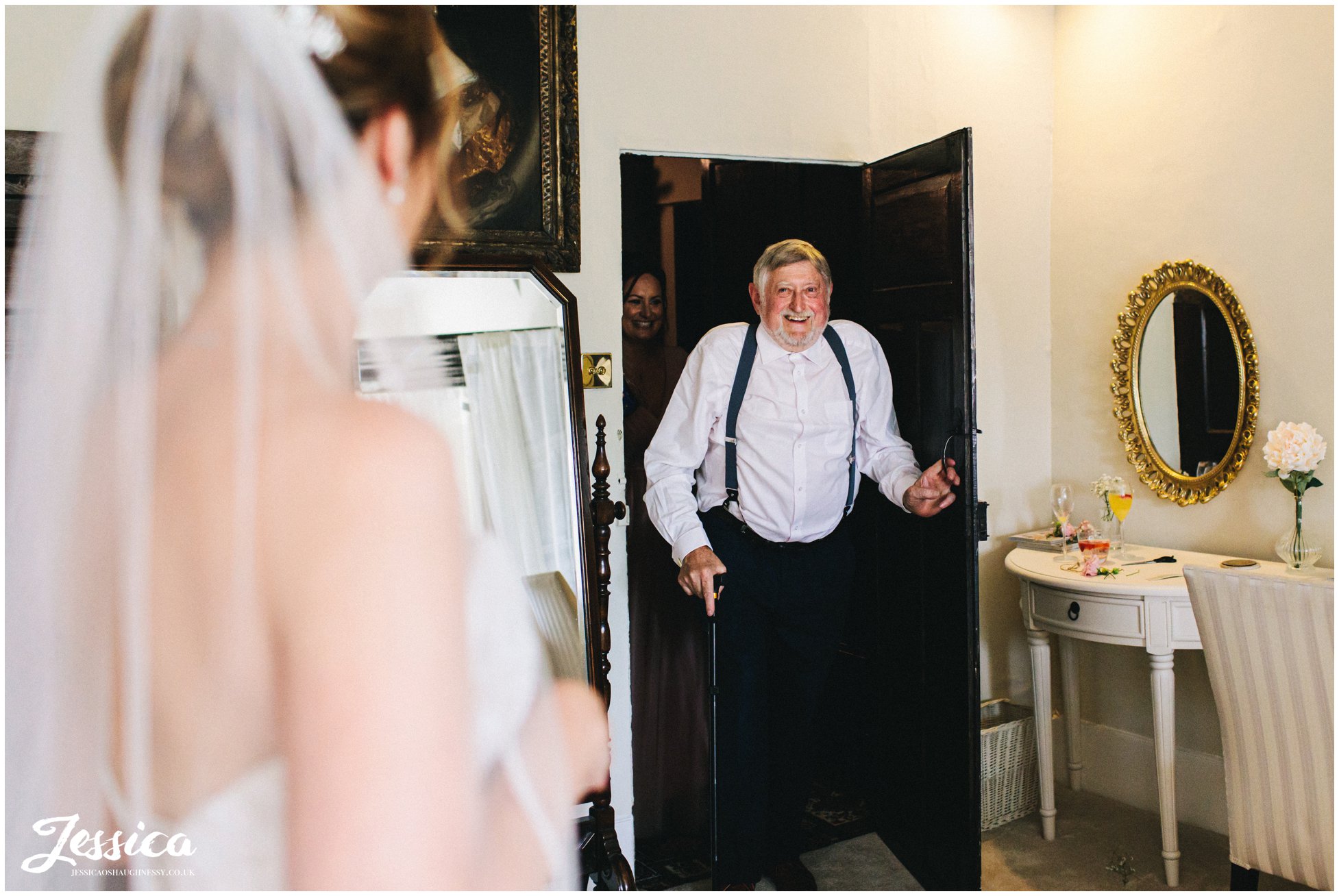 father of the bride sees his daughter in her dress for the first time
