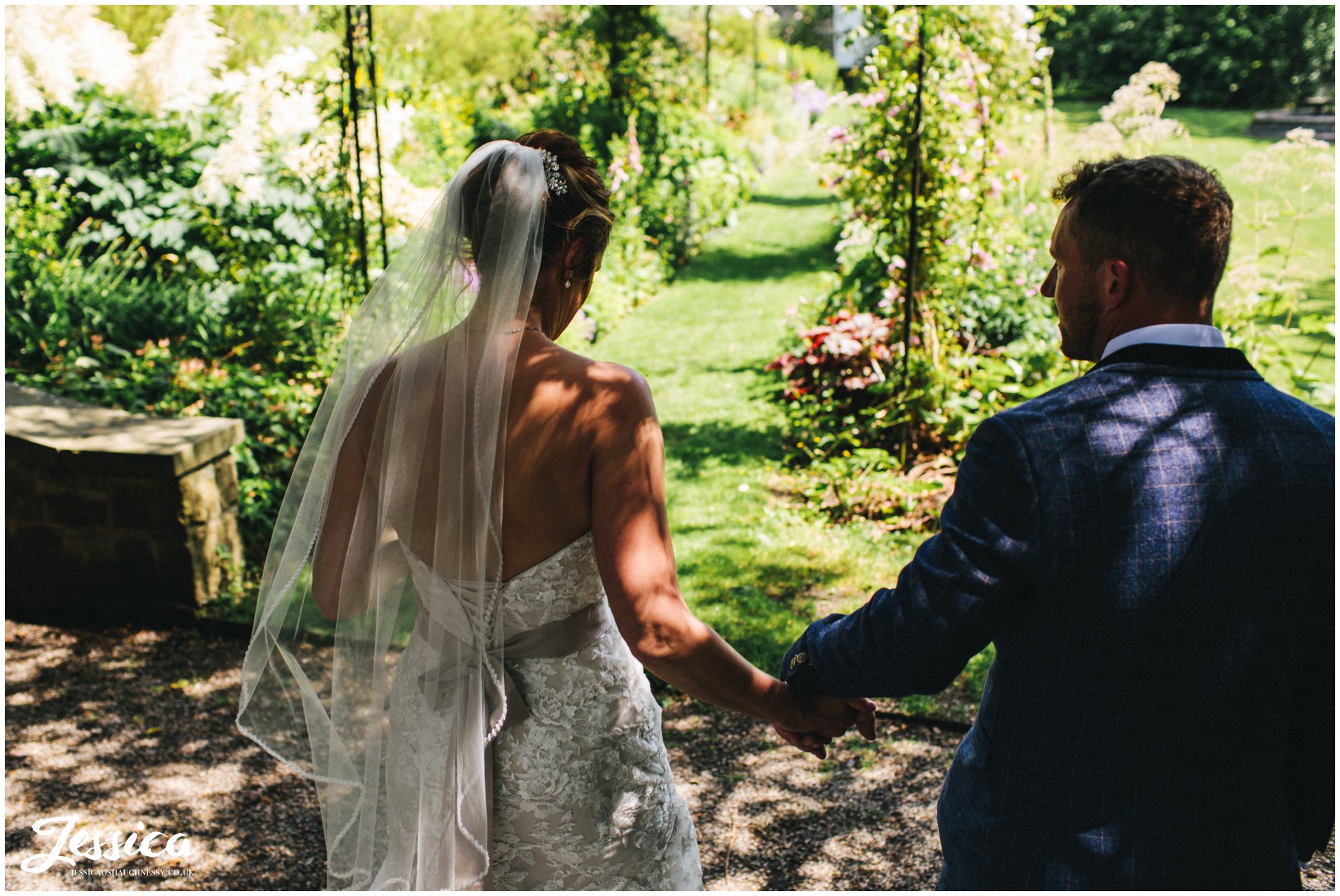 couple leas the way to the gardens at eyam hall in derbyshire