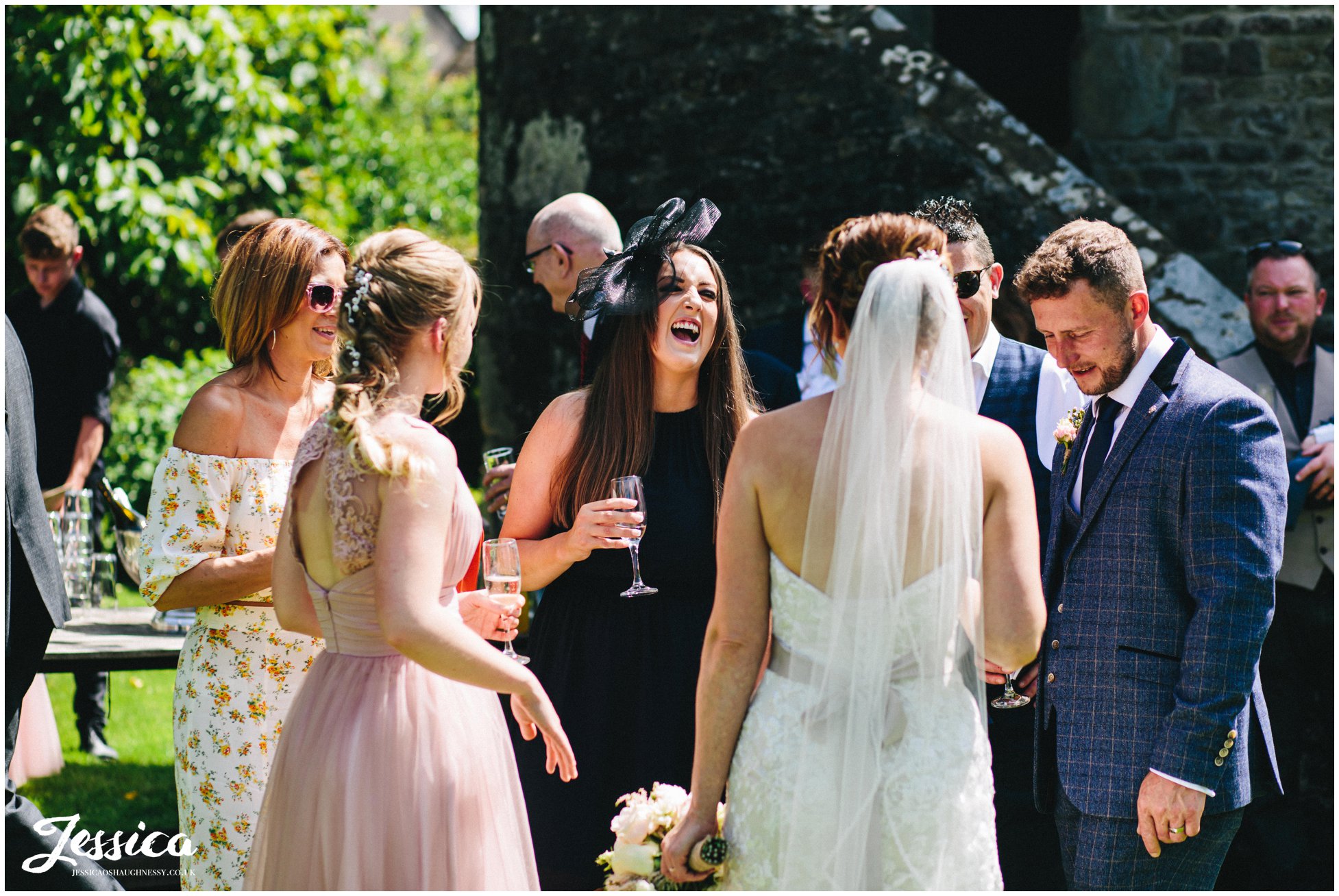 guests laughing during champagne reception