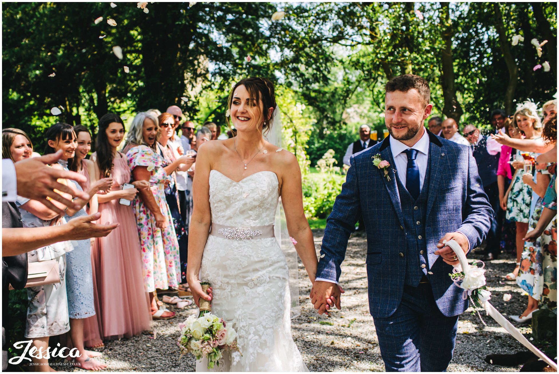 the couple are showered in confetti at eyam hall in derbyshire