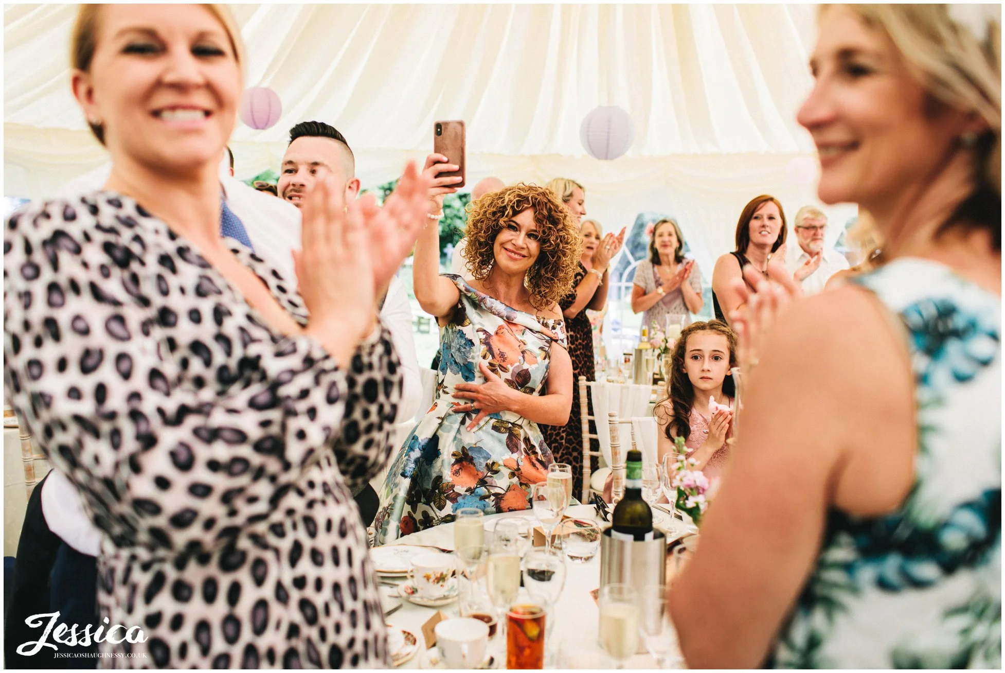 guests applaud the couple as they make their entrance