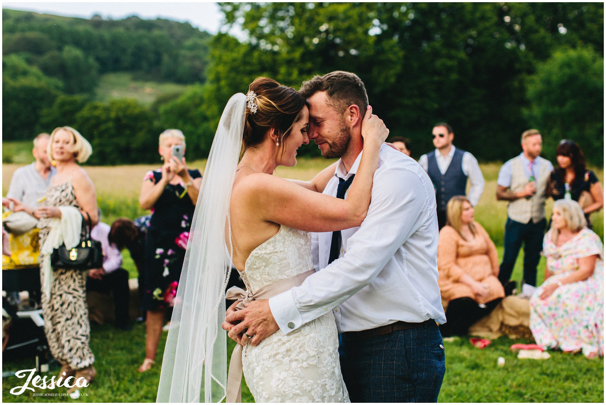 bride &amp; groom have first dance outside surrounded by guests