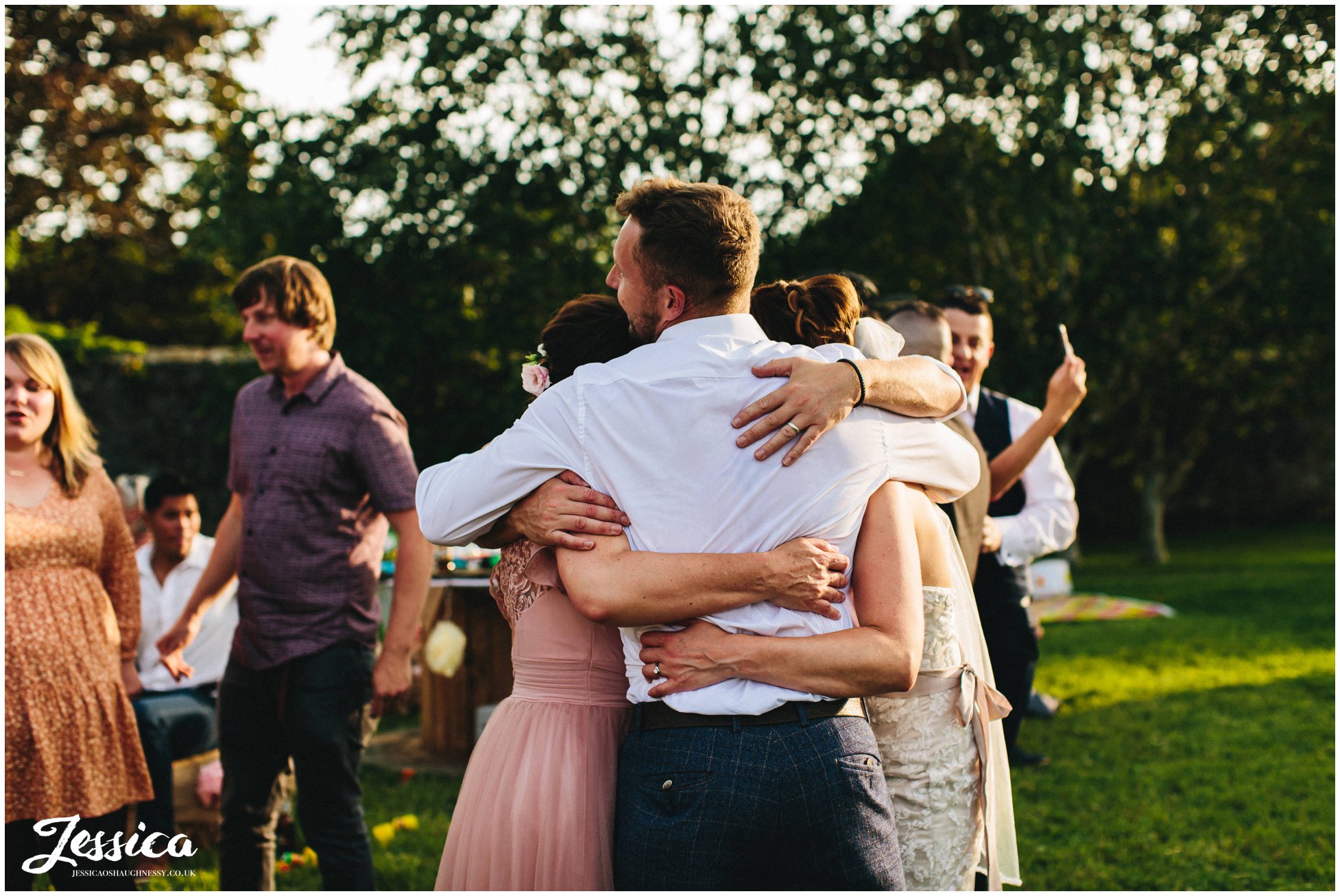 guests have group hug after the first dance ends