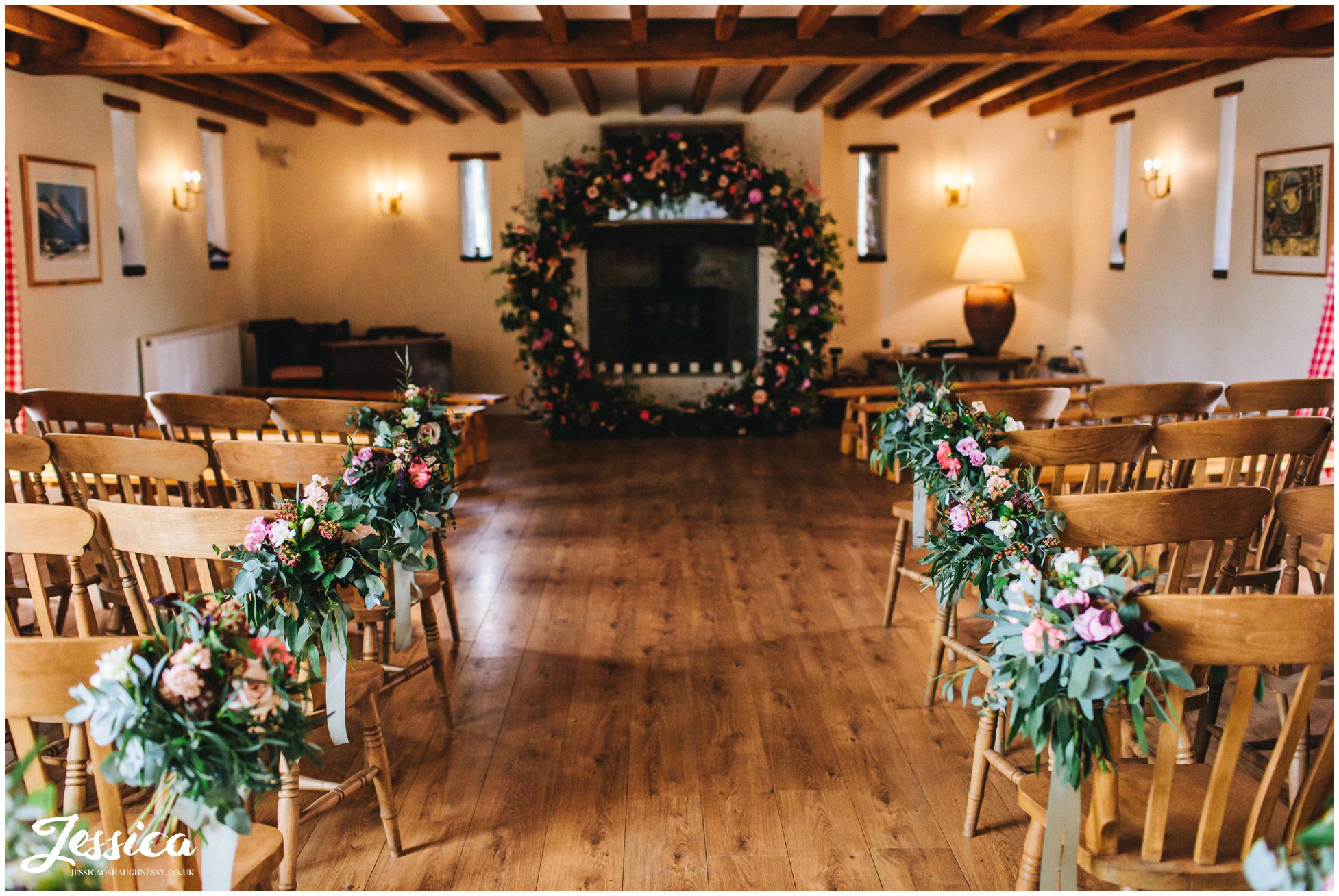 the ceremony room at the outbuildings is decorated in flowers