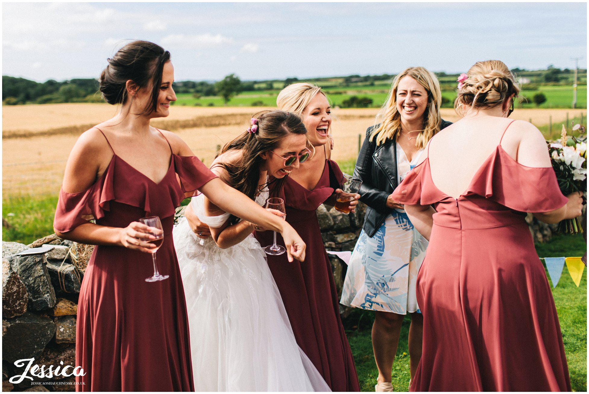bride laughs with her bridesmaids during the reception