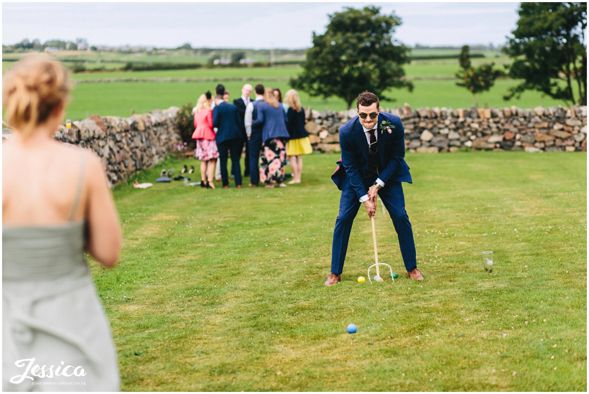 groom plays croquet at his north wales tipi wedding