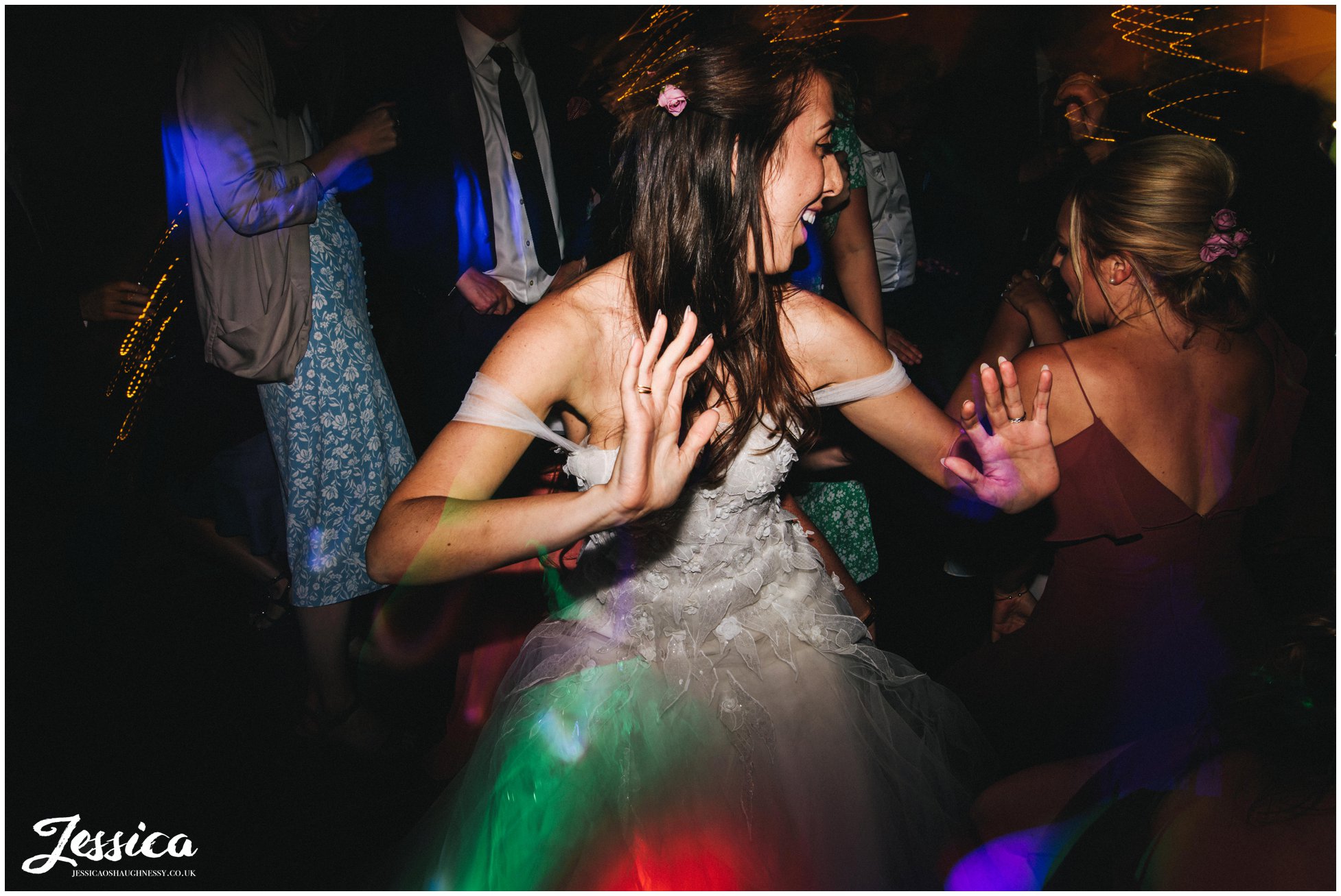 bride dances with friends at the outbuildings