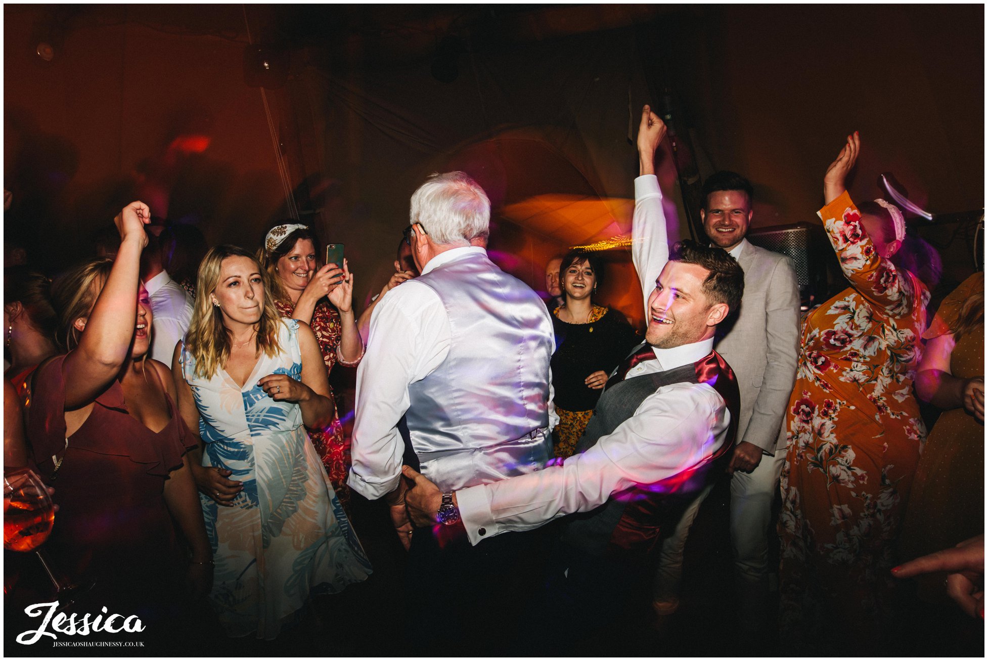 groom dances with dad in the tipi