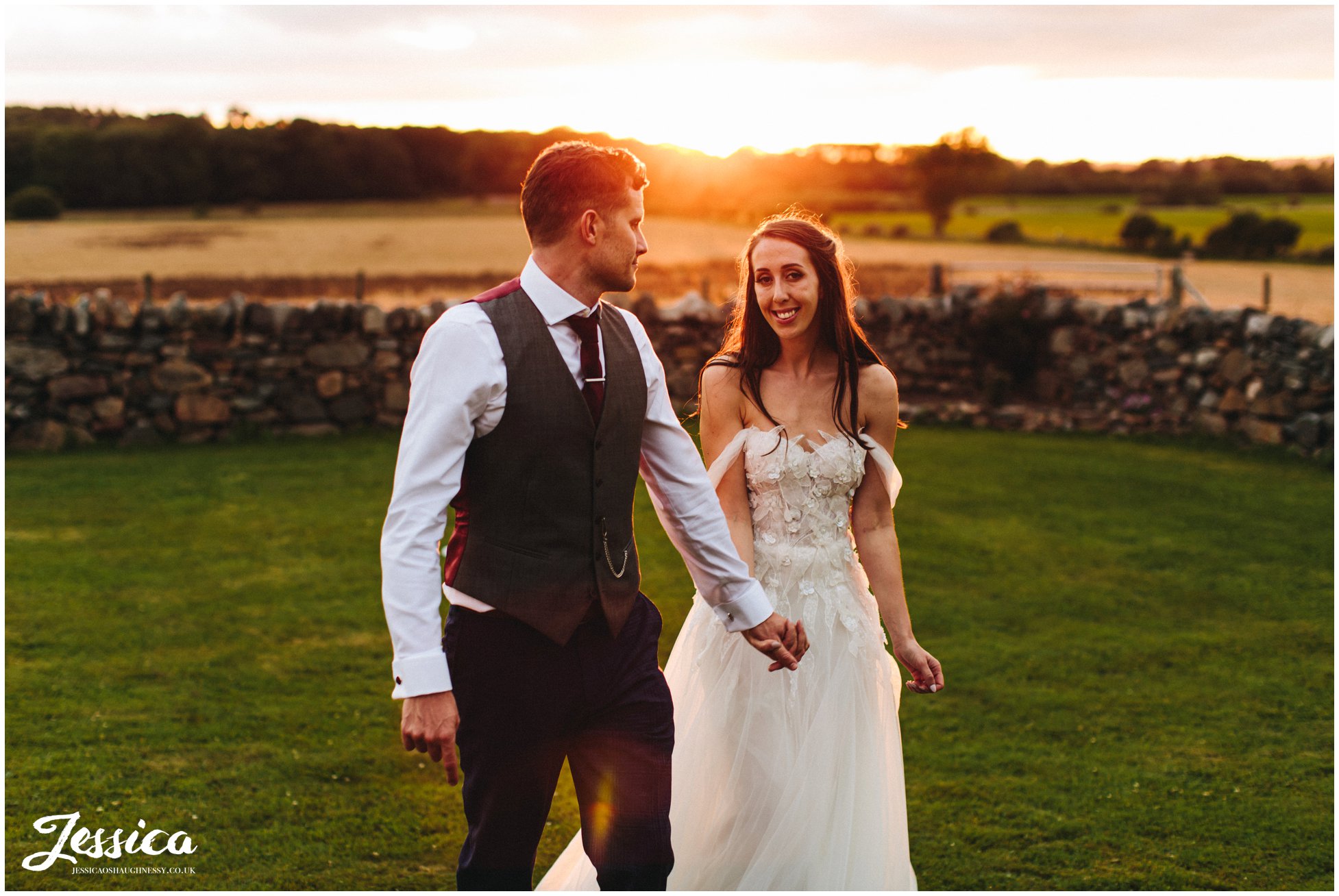 newly wed's walk together during golden hour