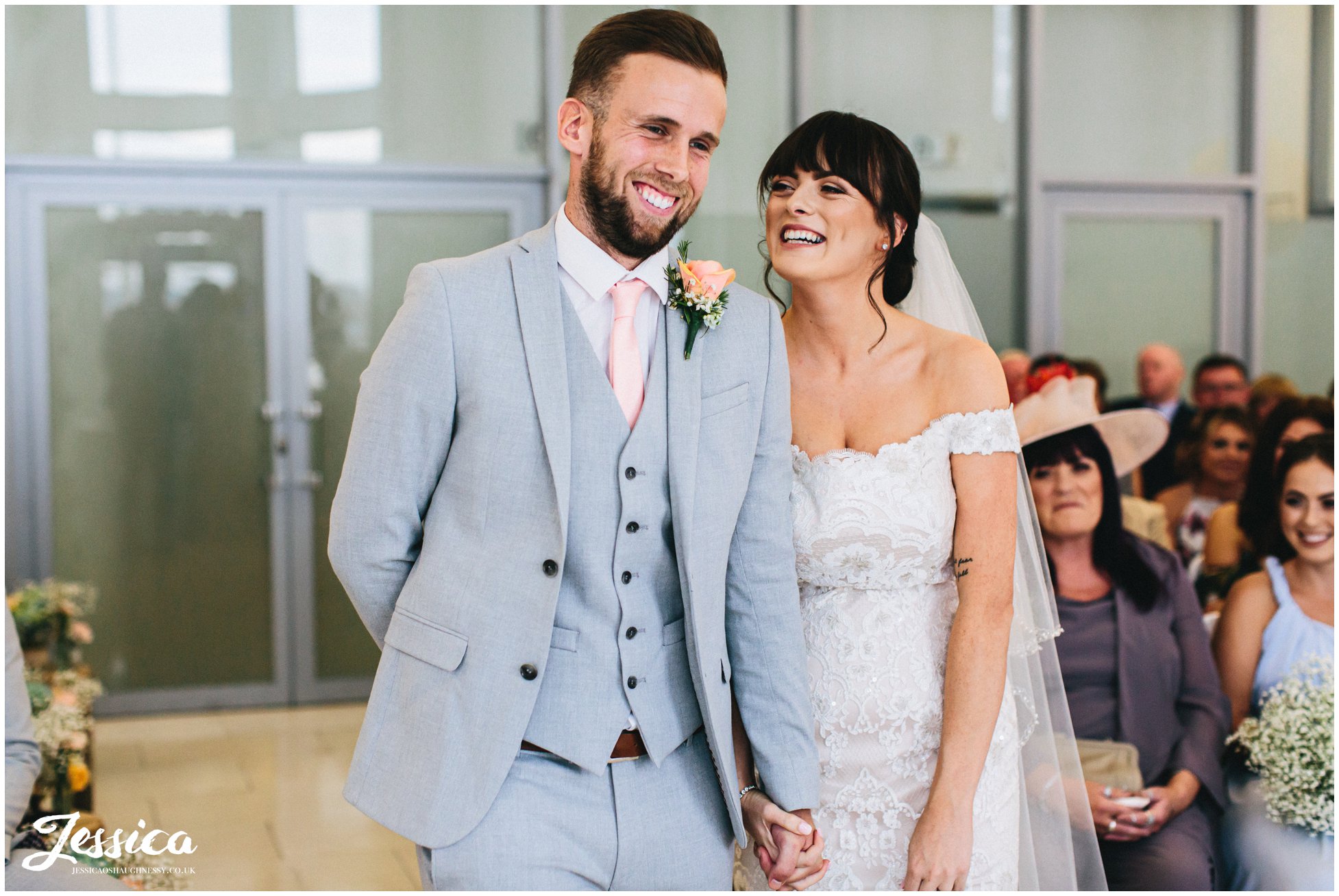 the couple laugh together during their liverpool wedding