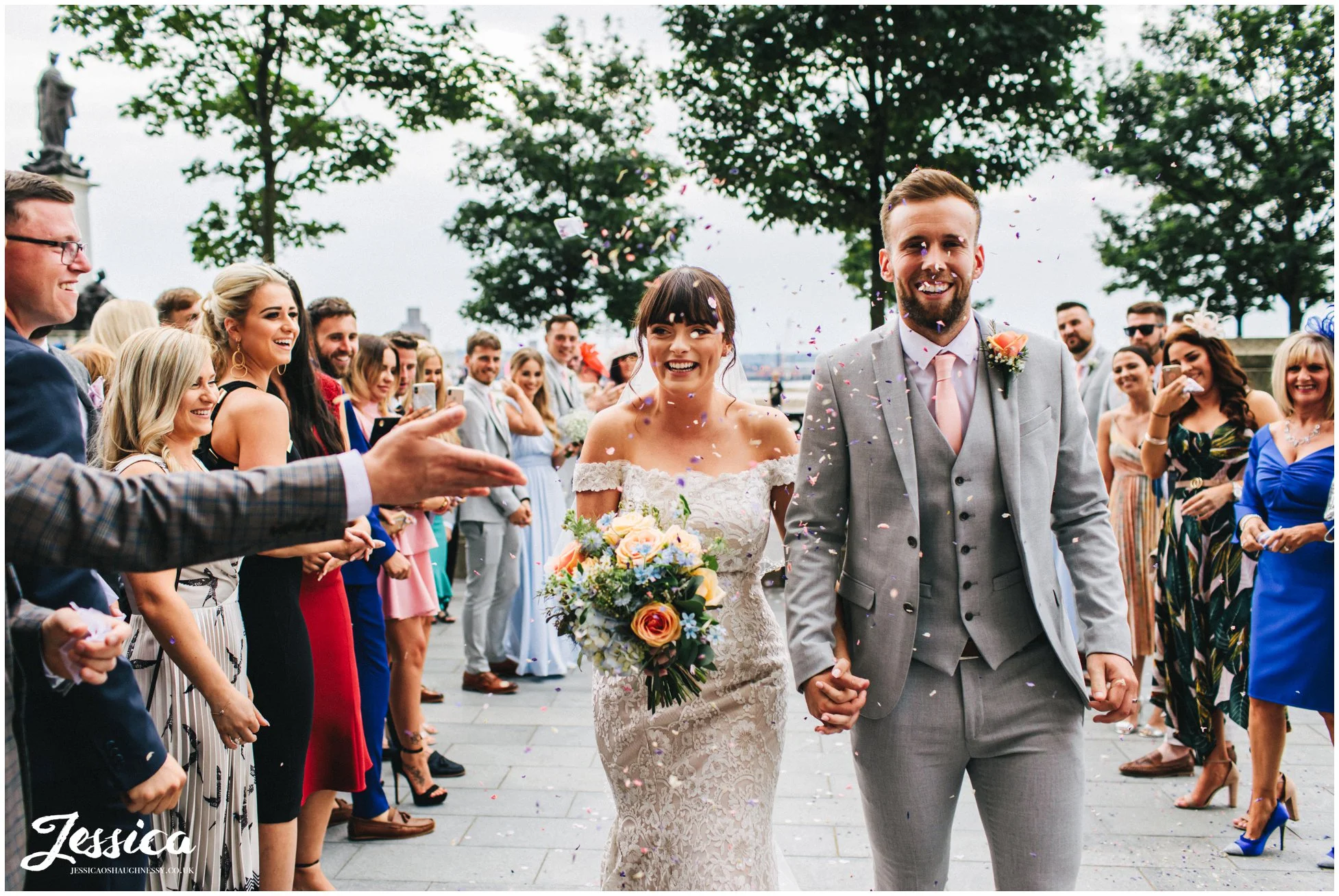 guests shower the couple with confetti