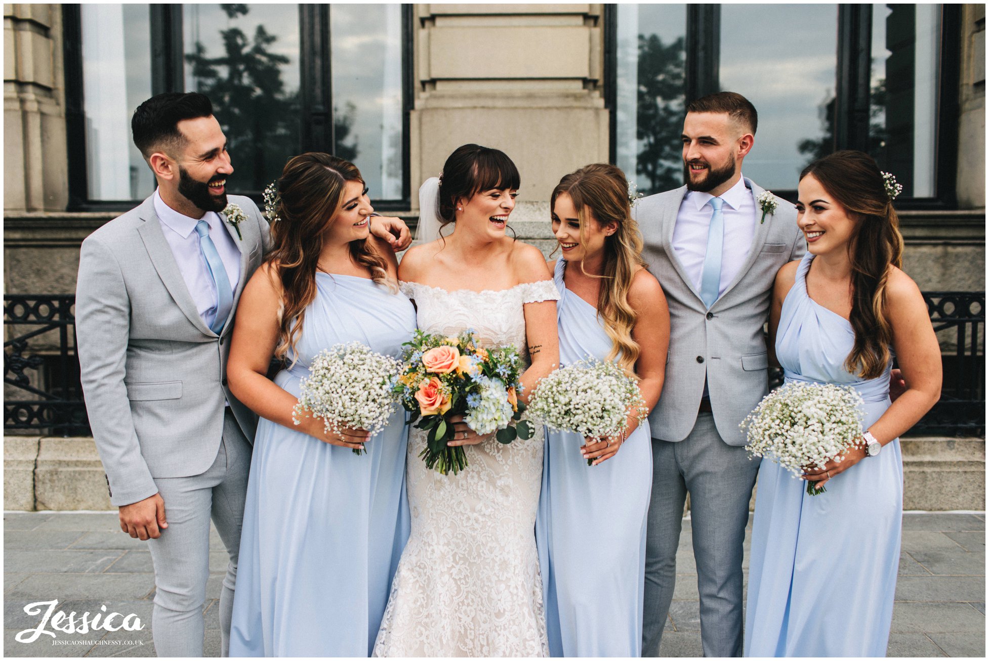 bride laughs with her bridal party