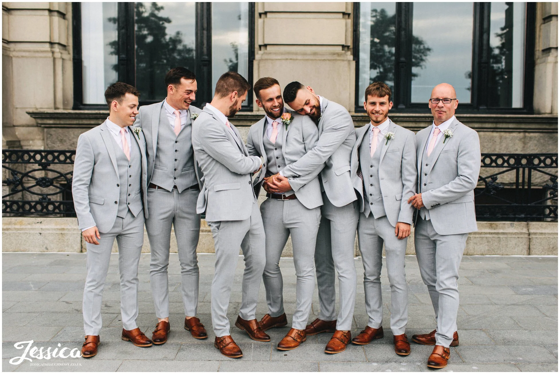 groom & groomsmen joke around outside the liver building