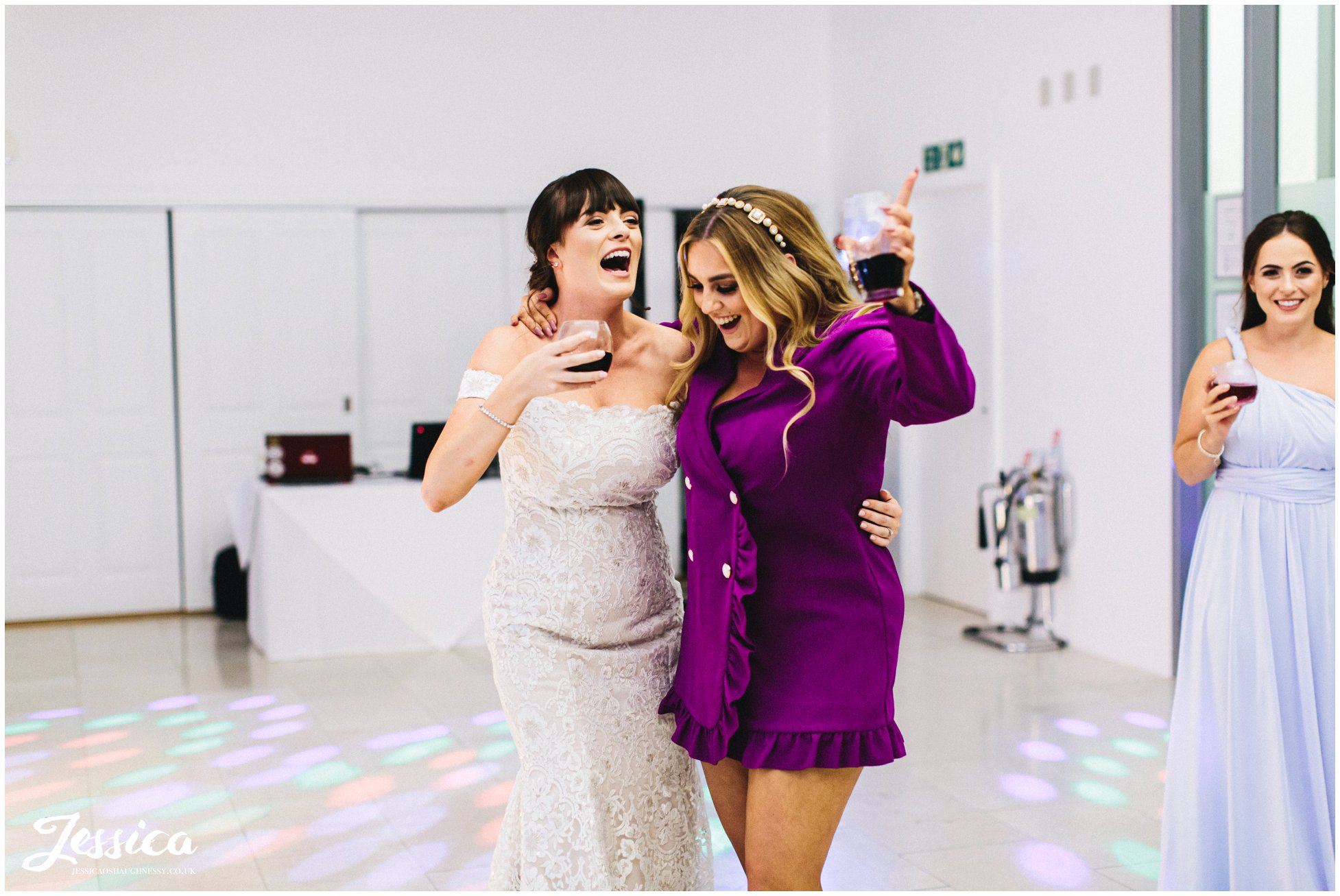 bride dances with her friend during the wedding reception