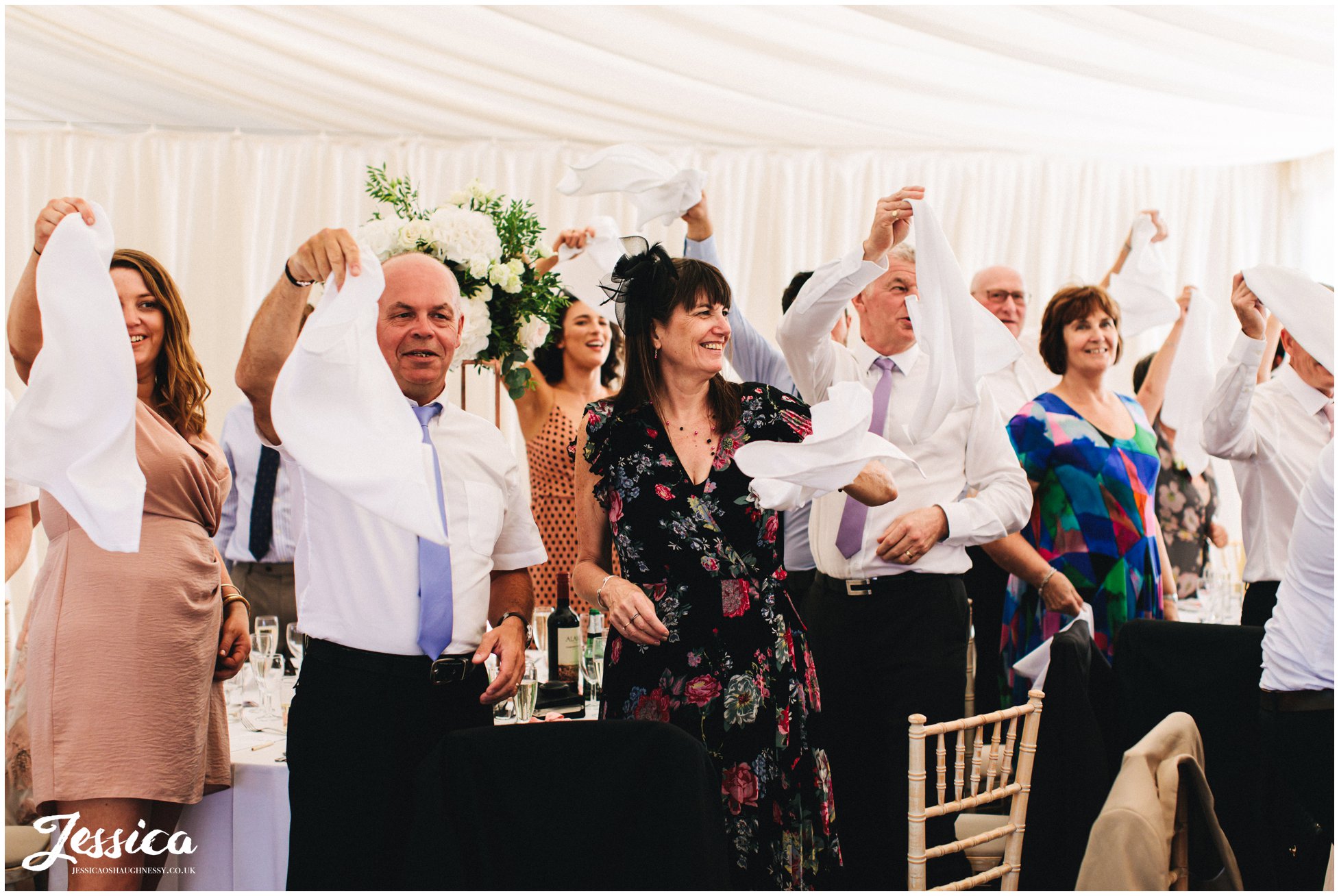 guests wave their napkins as the newly wed's are announced in