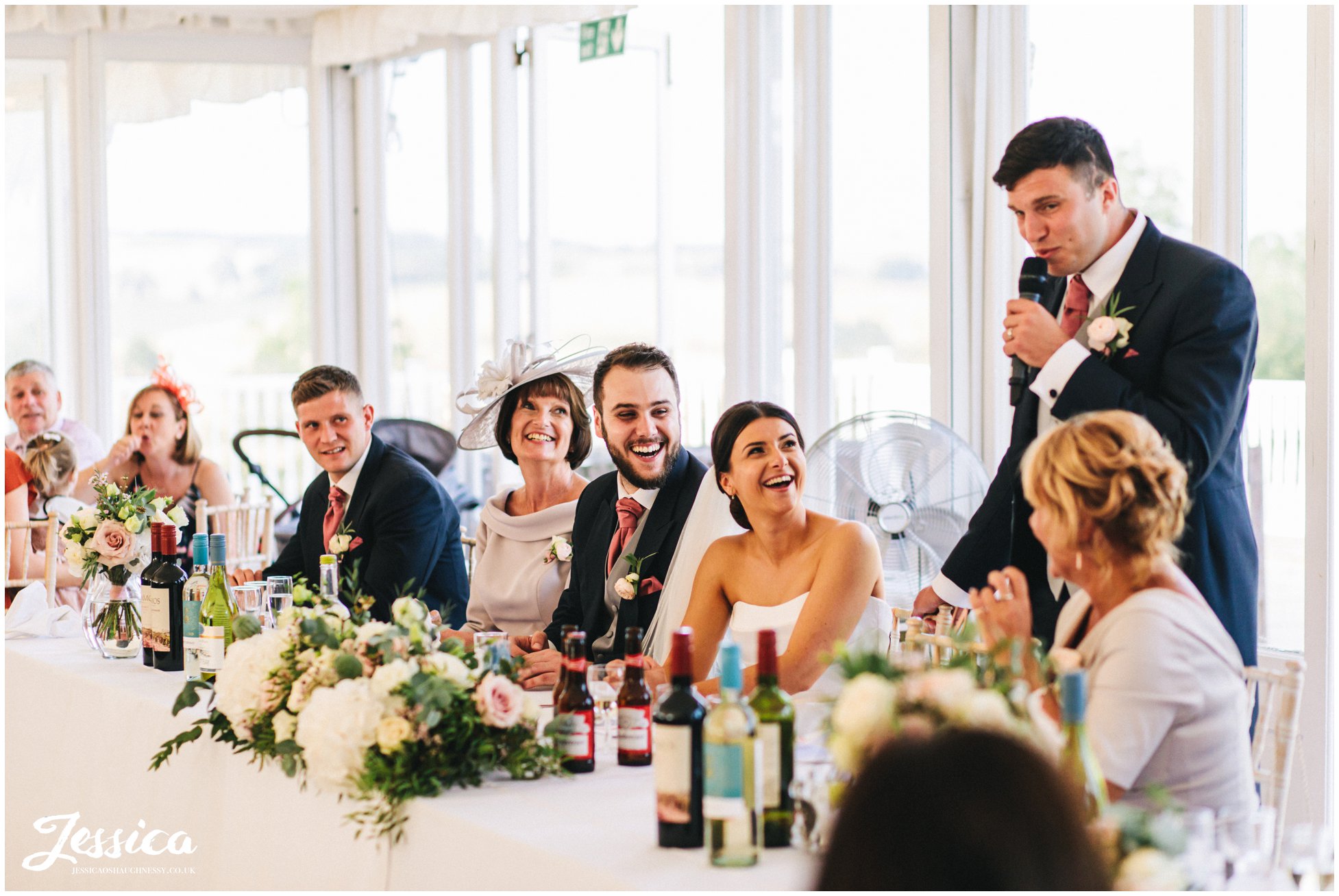 groom makes top table laugh during his speech