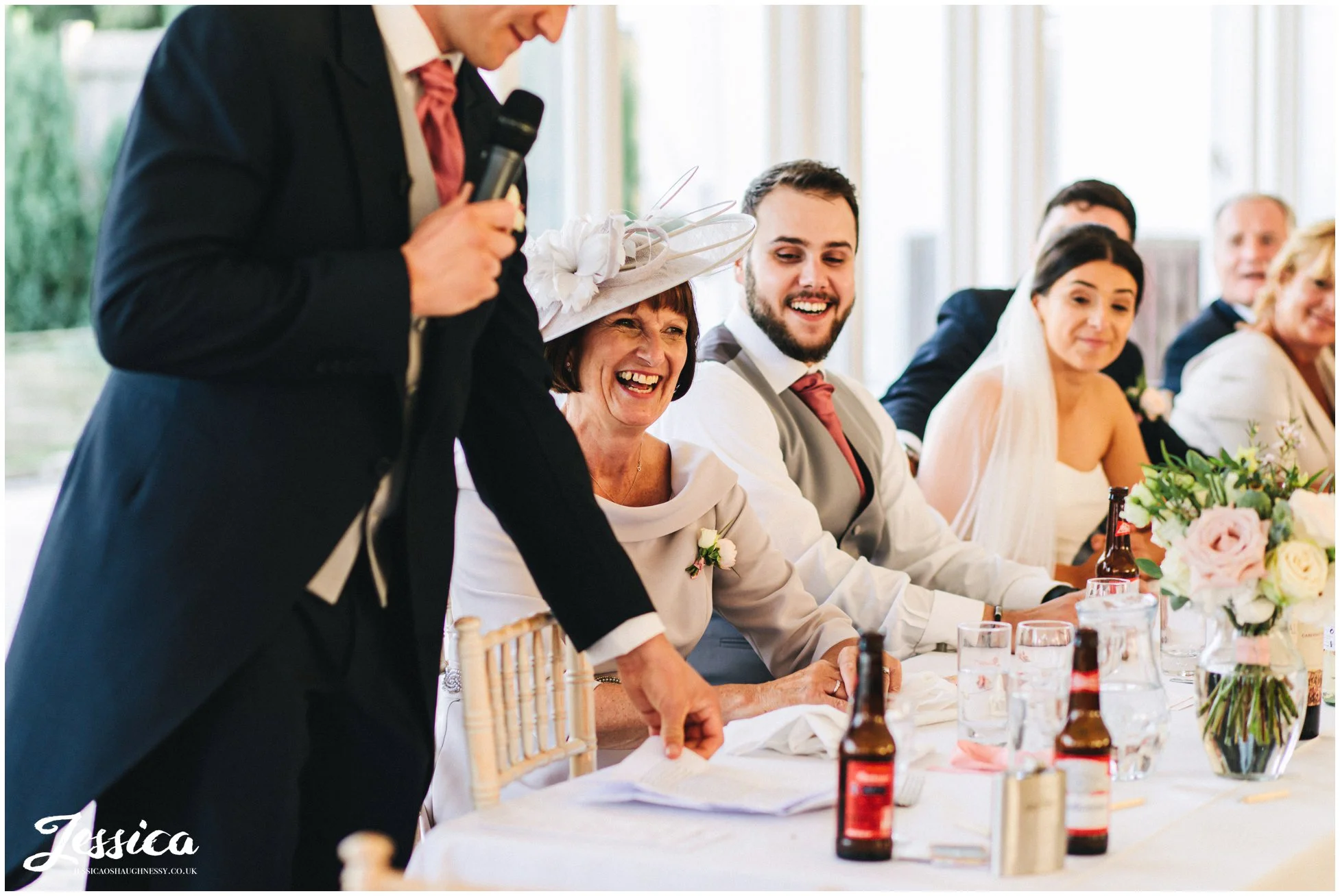 mother of the groom laughs during the best mans speech