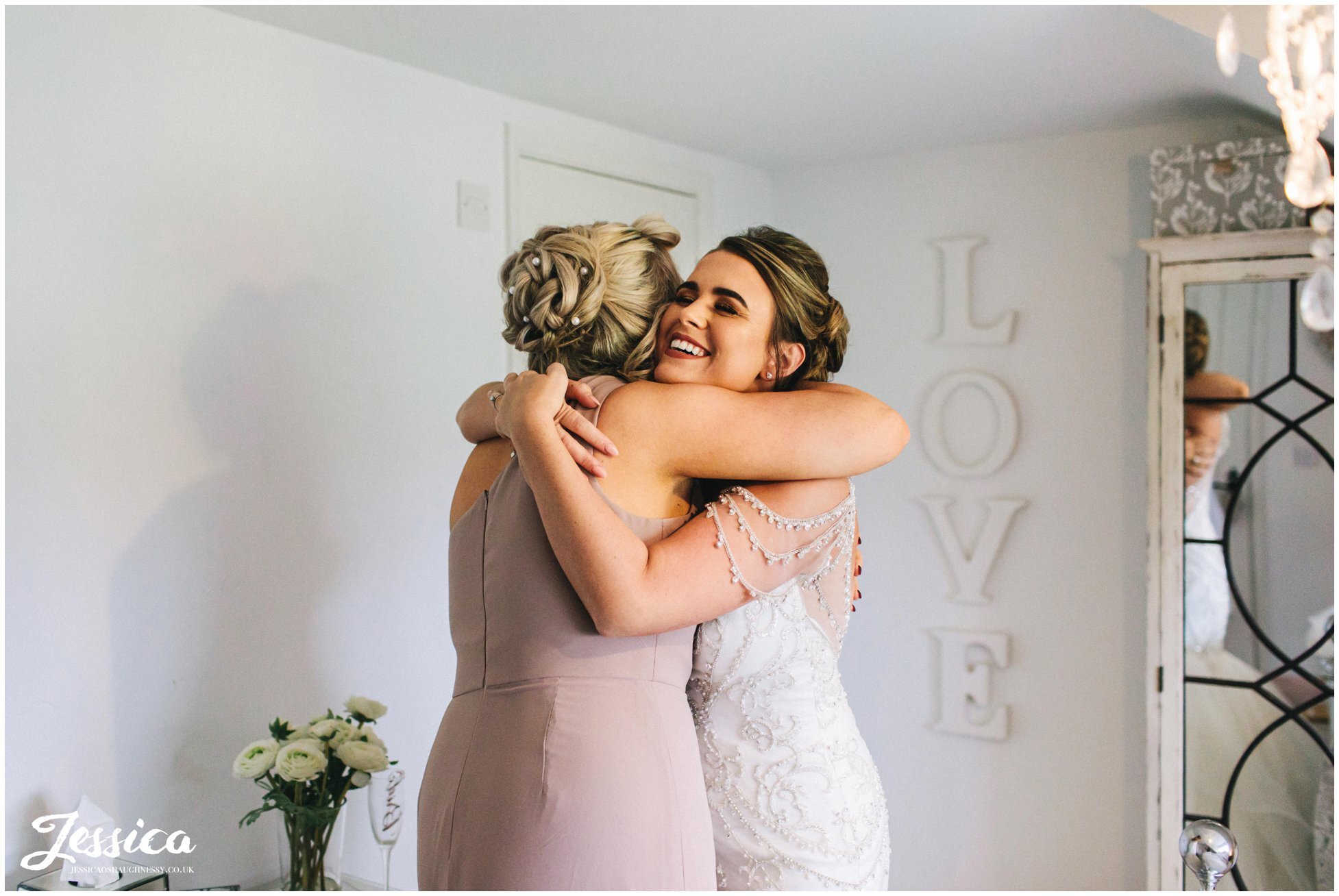 bride hugs her sister before the cheshire wedding