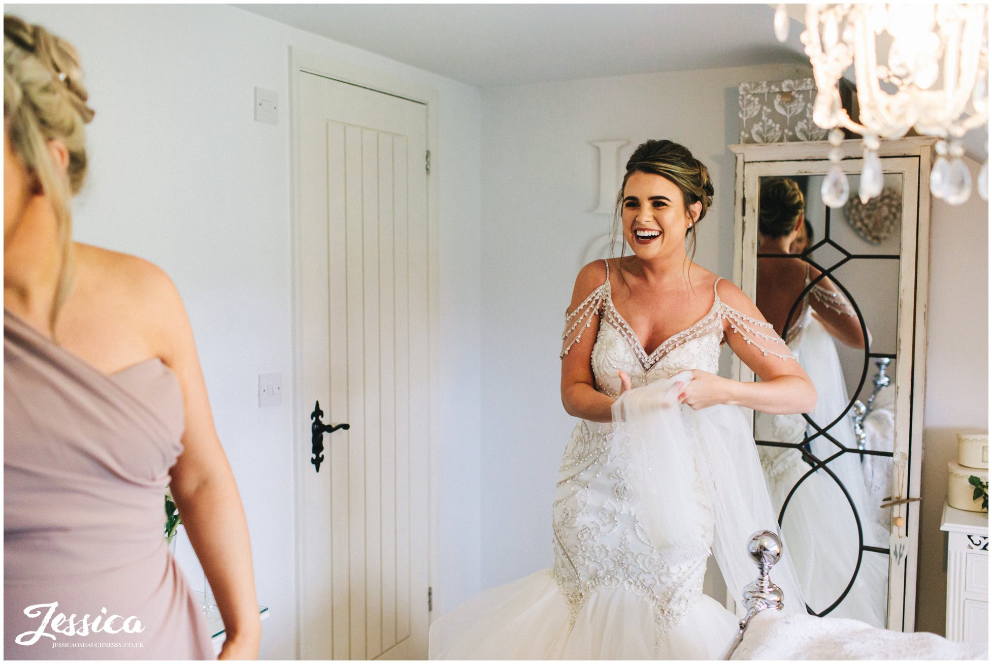 bride laughs as she gets ready for the wedding