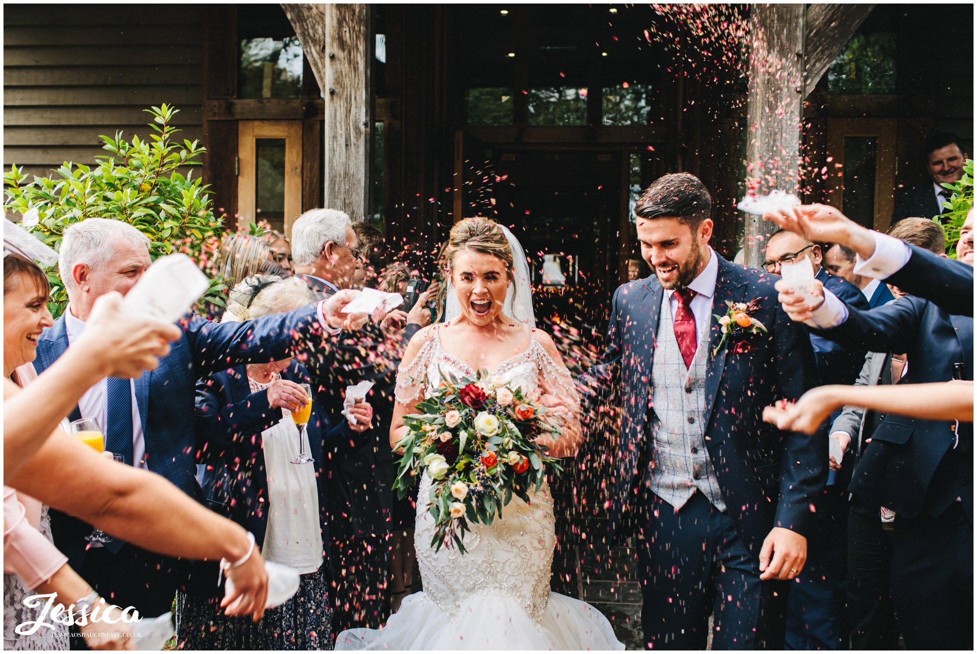 couple get showered in confetti outside the oak tree of peover