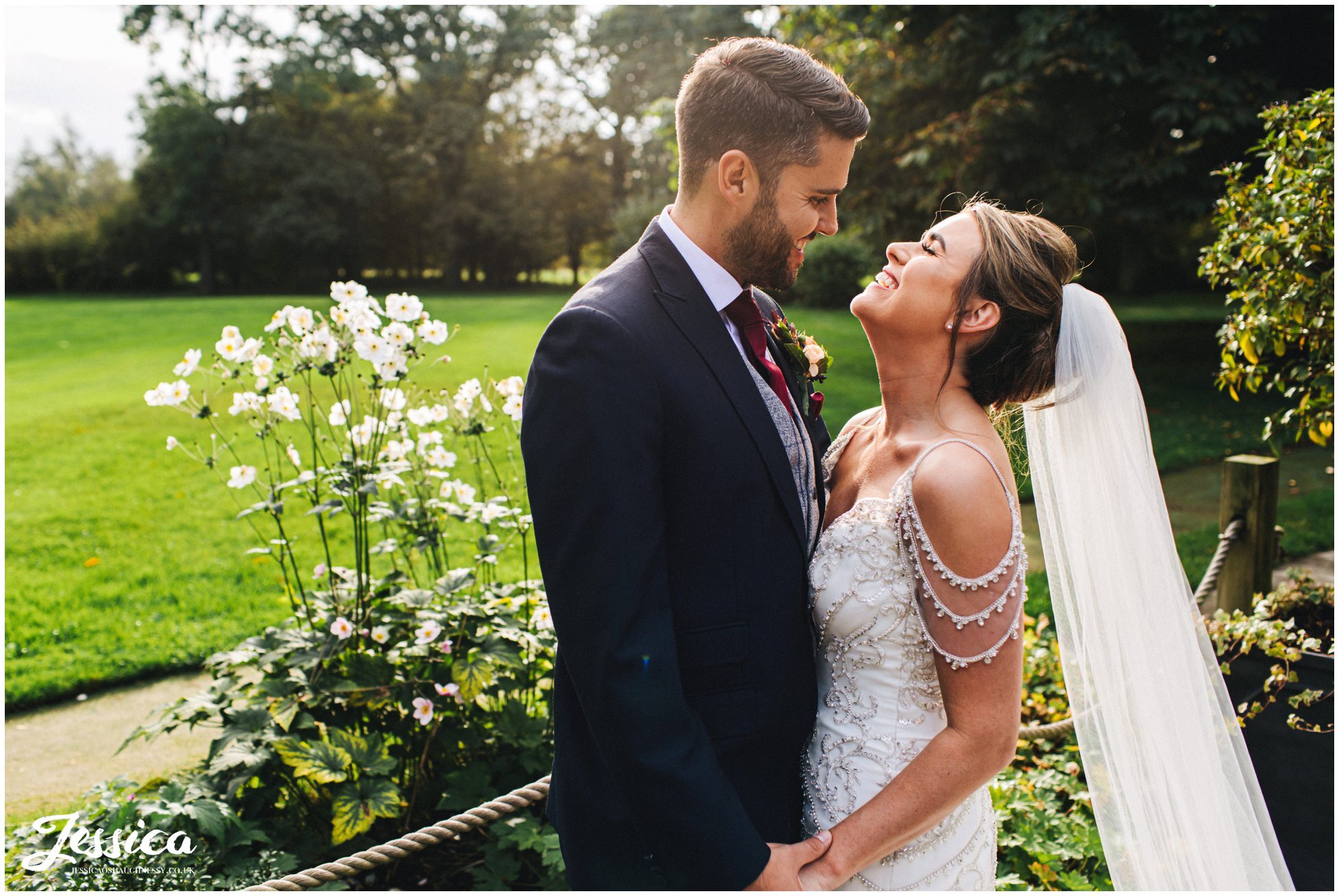 couple laugh together on their wedding at at the oak tree of peover