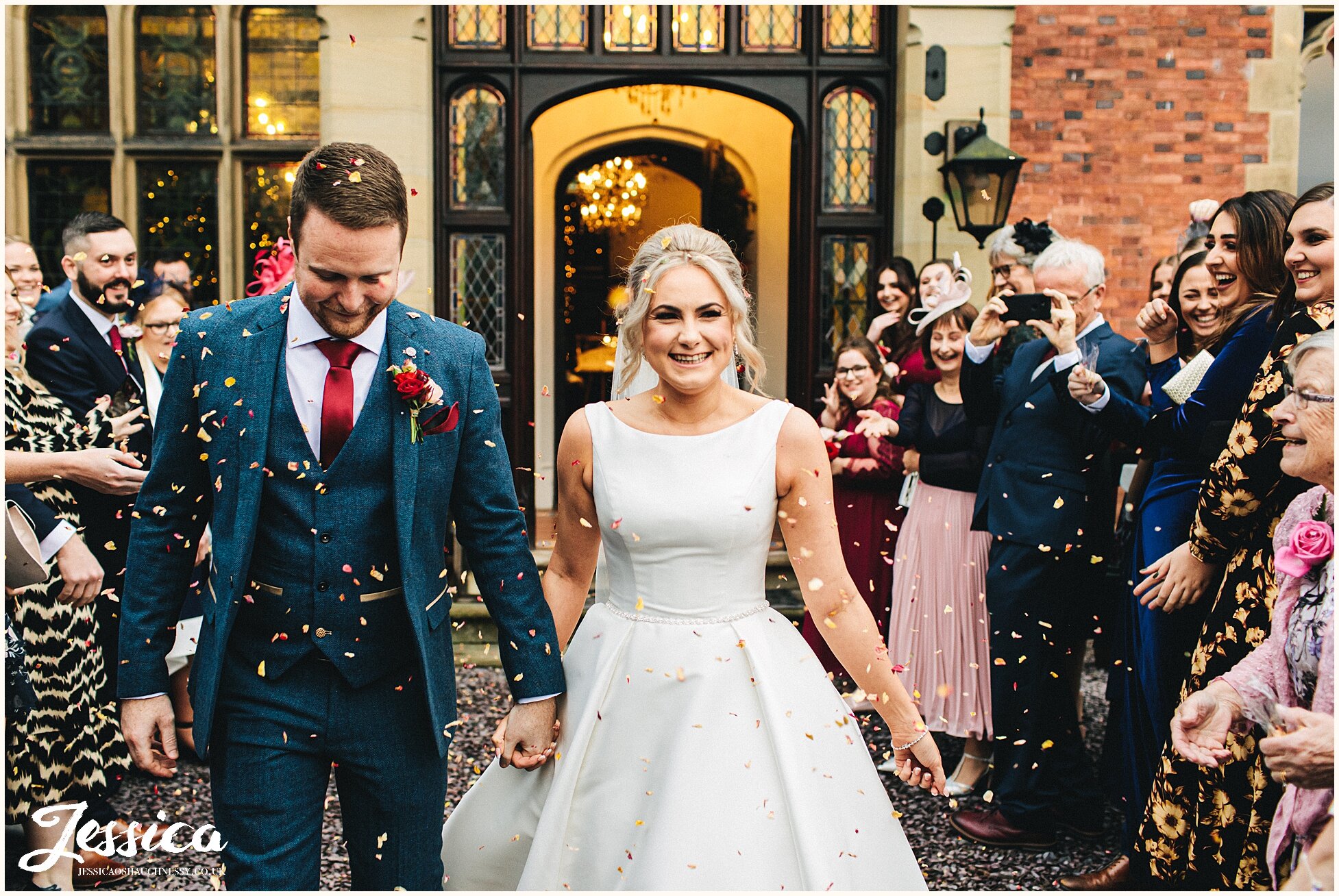 couple showered in confetti at their winter wedding
