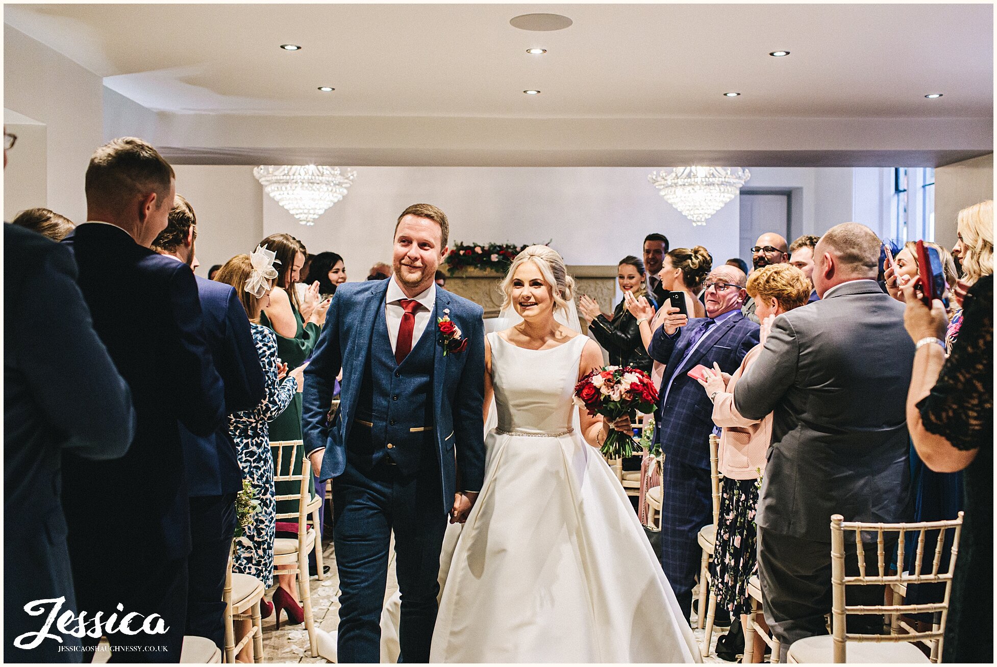 couple walk back down the aisle as husband and wife