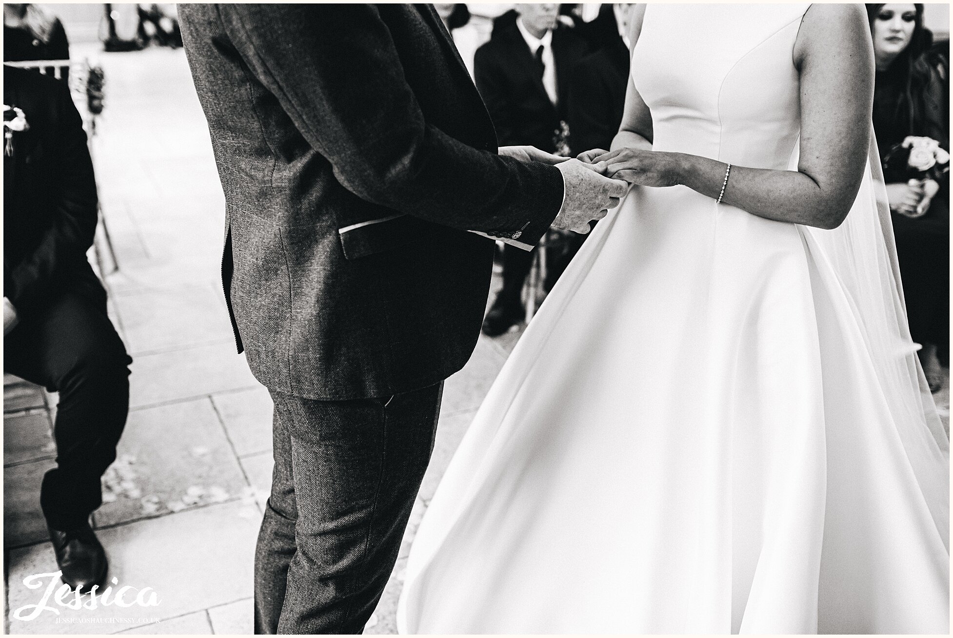 couple hold hands before they exchange rings