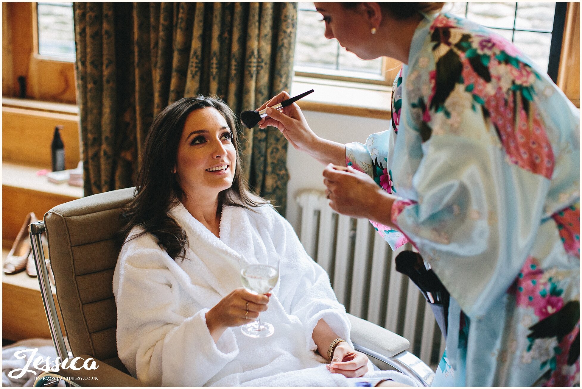 bridesmaid gets makeup done at the lost orangery wedding venue