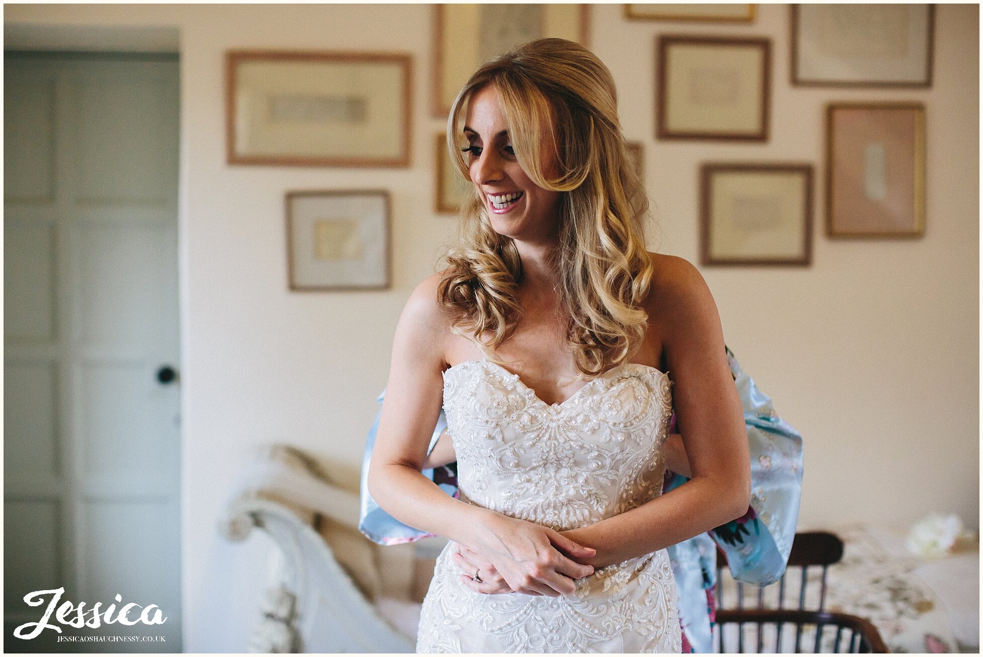 photograph of bridal bouquet whilst bride gets into her wedding dress