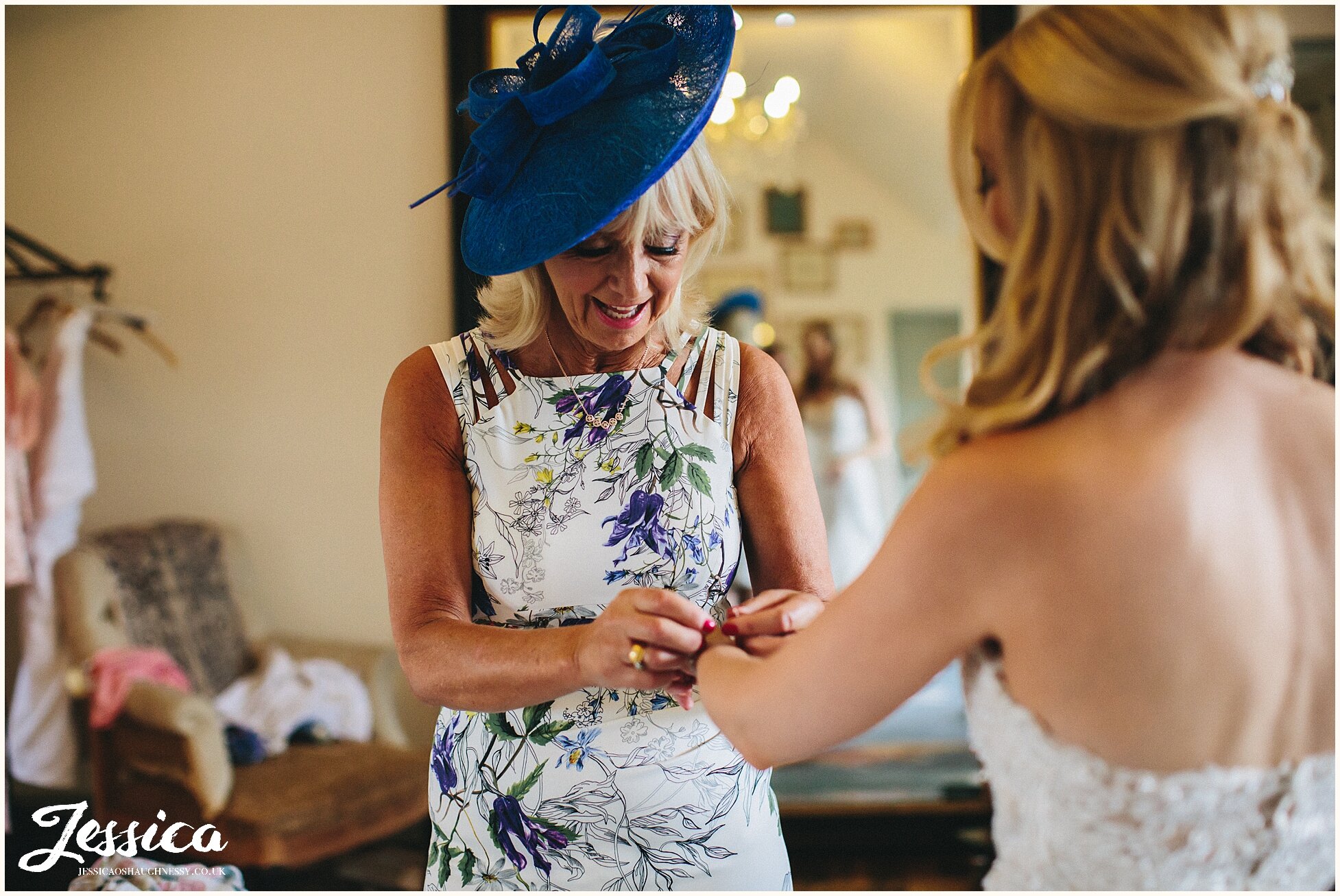 mother of the bride putting brides jeweller on