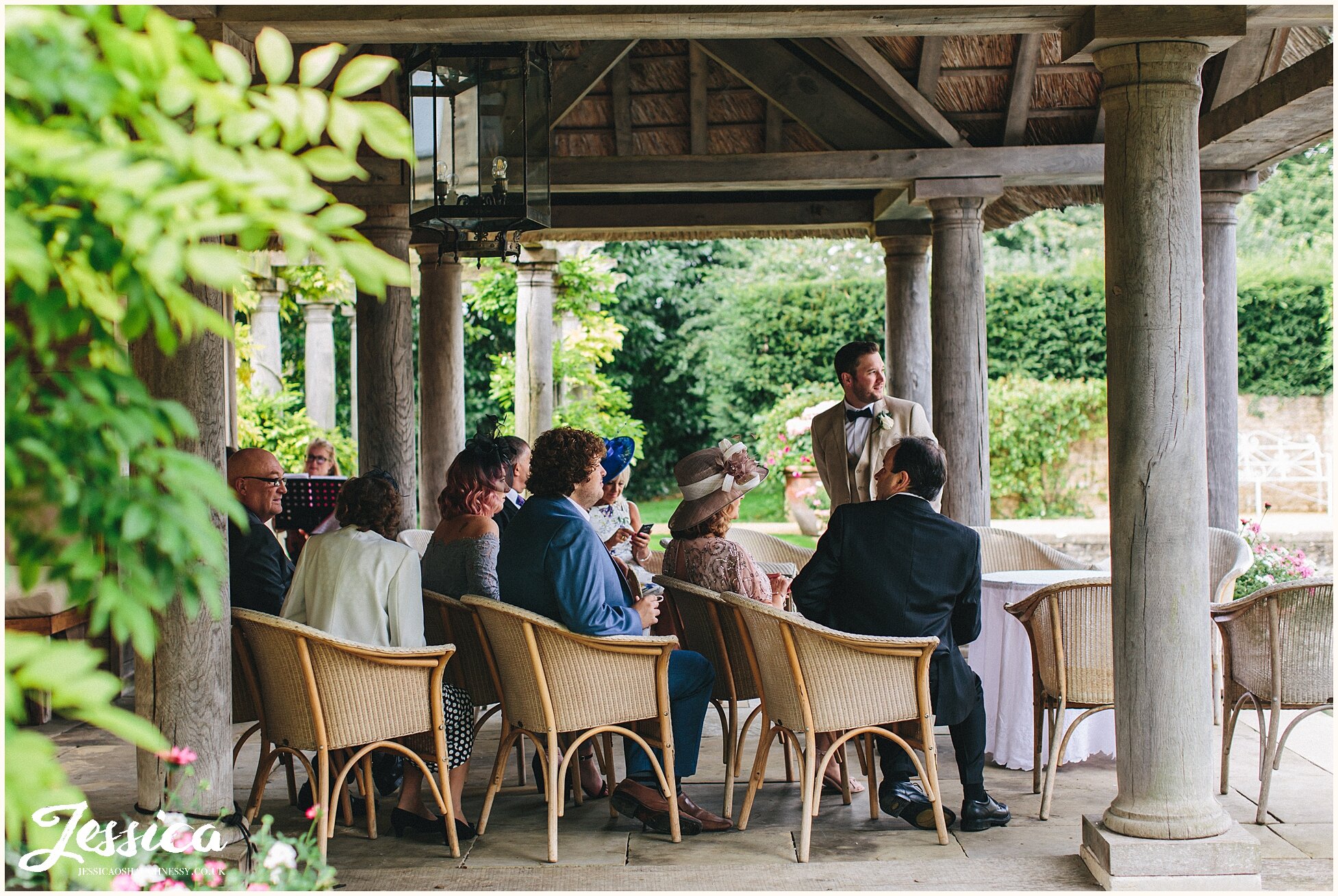 groom nervously waits for bride under the boathouse - cotswolds wedding photography