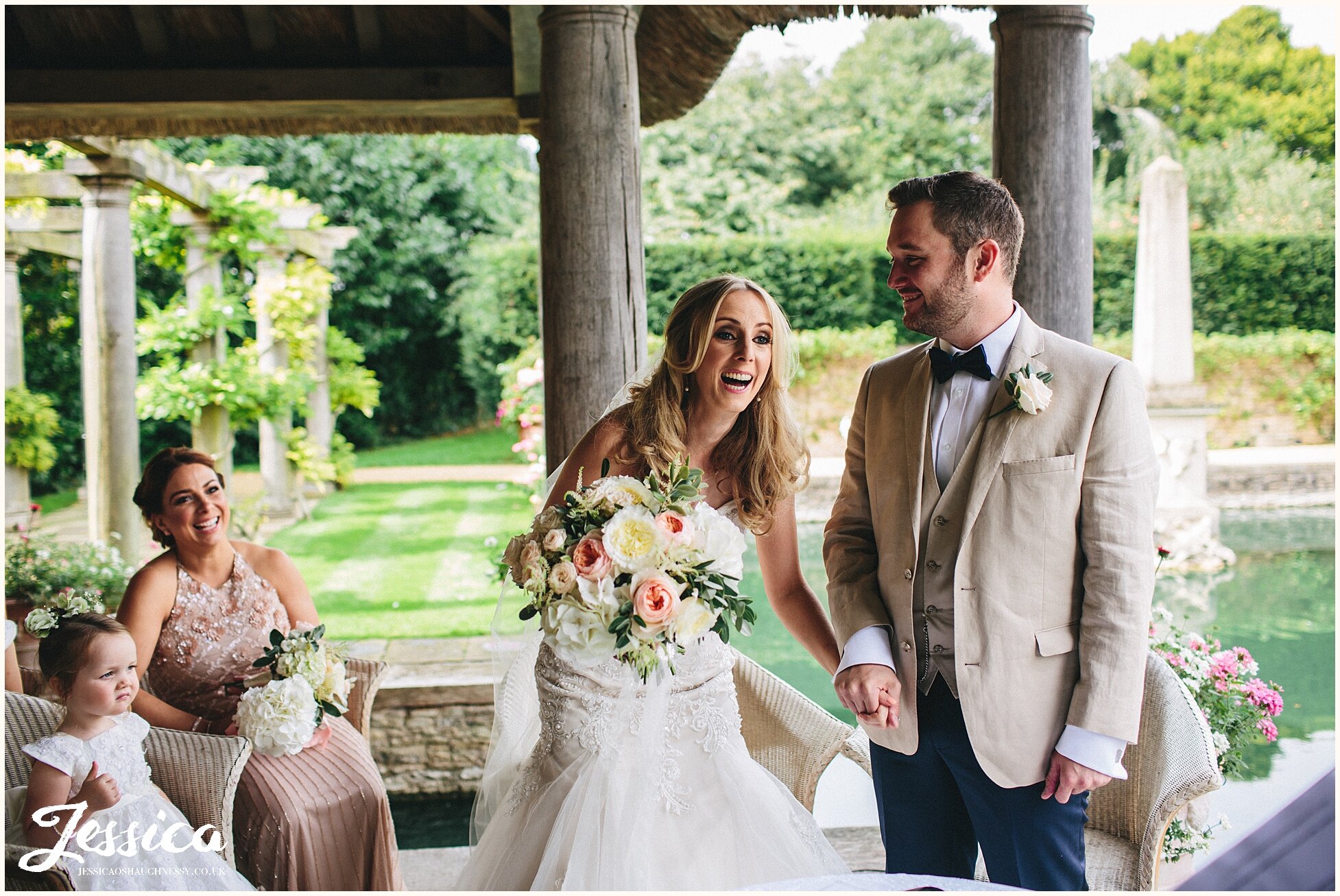 couple laugh whilst exchanging their vows