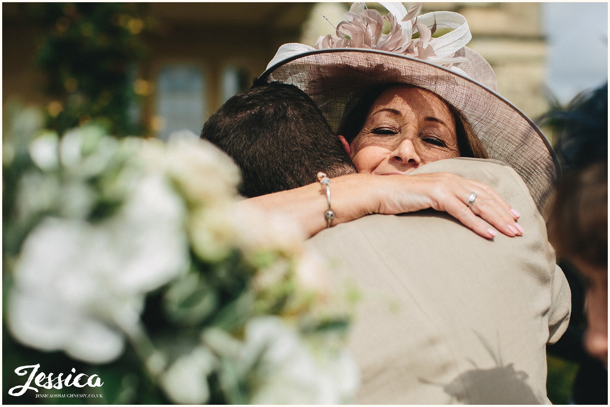 mother hugs her newly married son - the lost orangery wedding in cotswolds