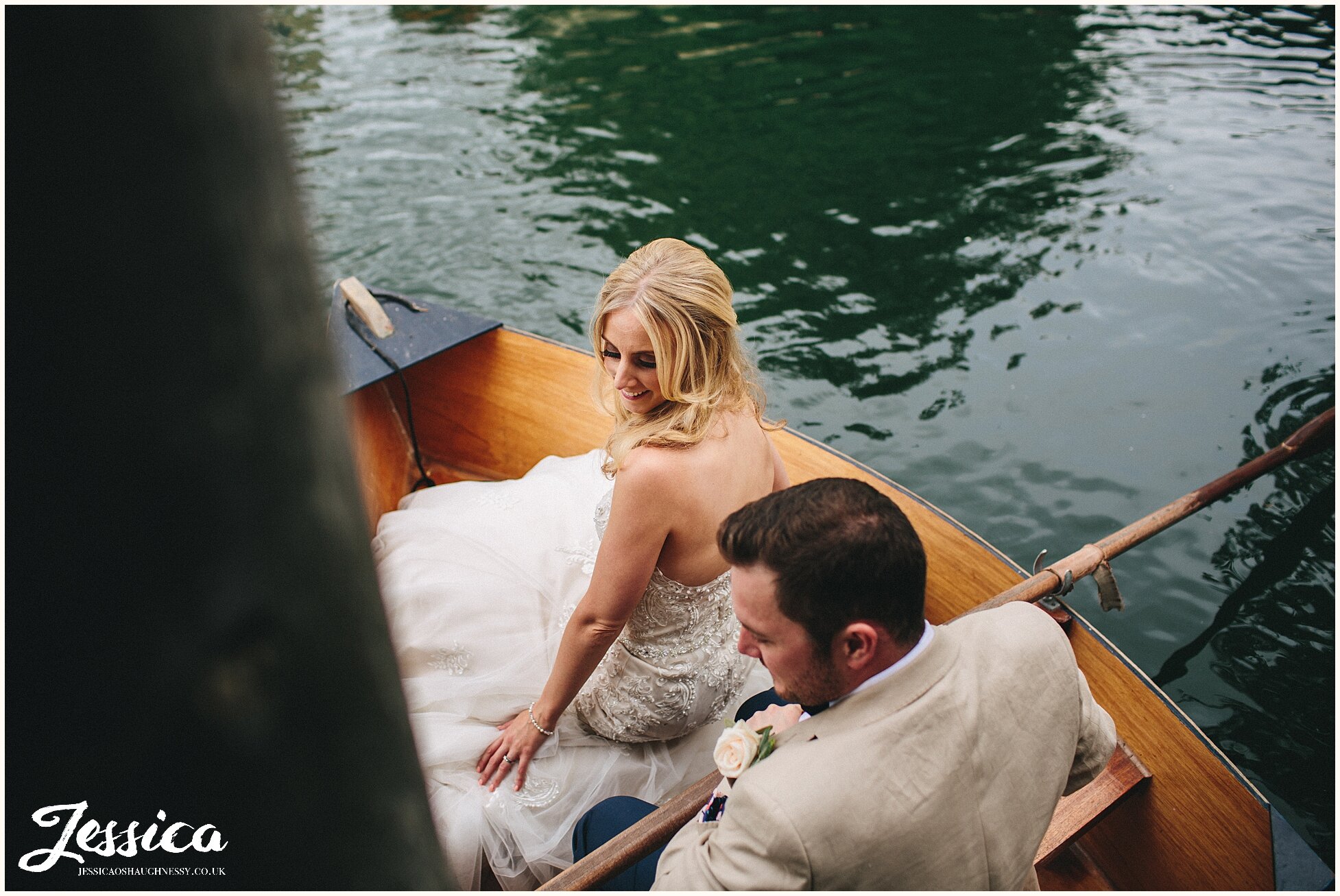 bride being rowed on the lake