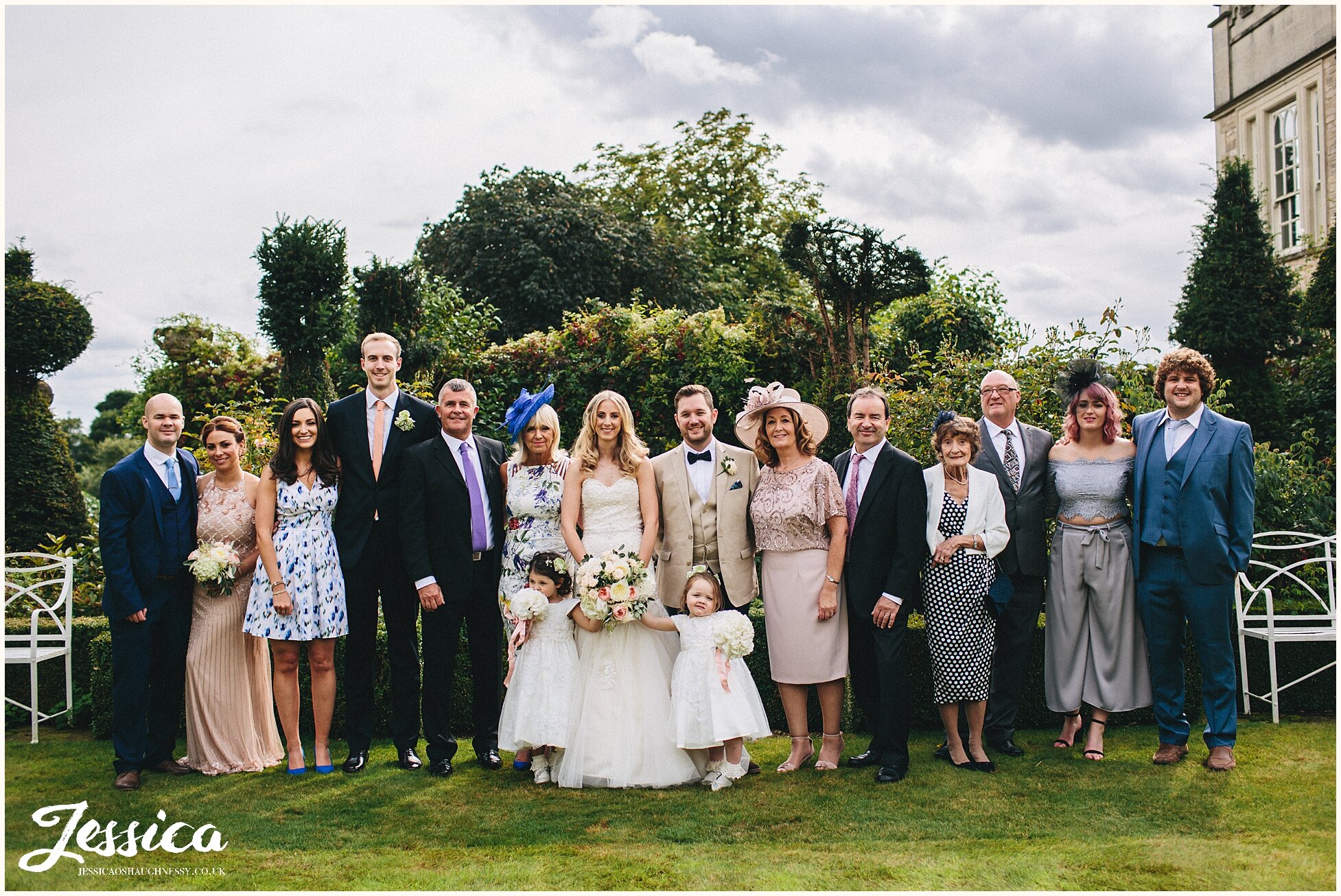 group photograph of the guests at the cotswolds wedding