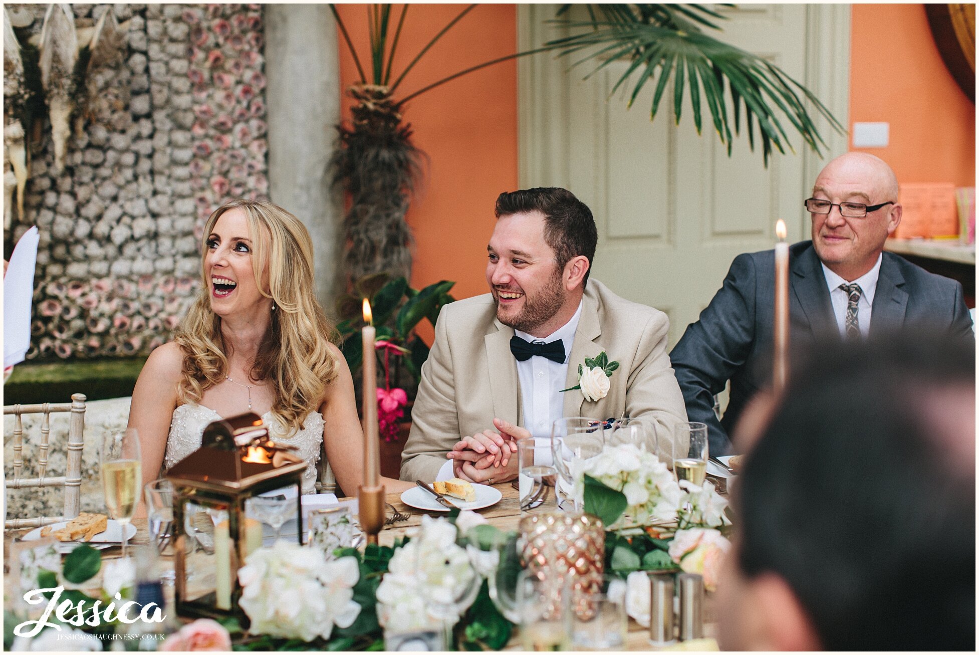 newly wed's laughing during funny moment of speech