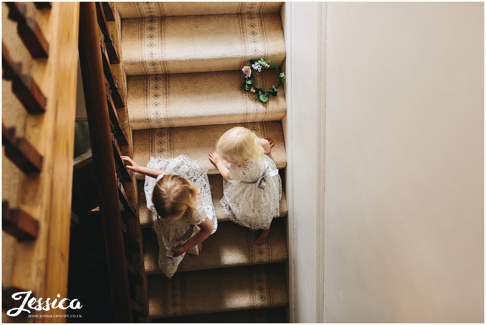 flower girls play on the stairs - liverpool wedding photographer
