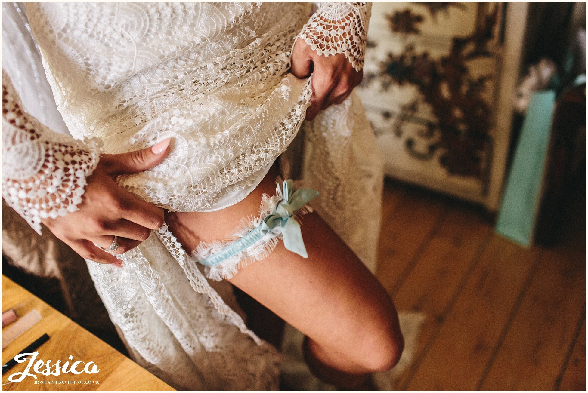 bridesmaid puts on brides garter