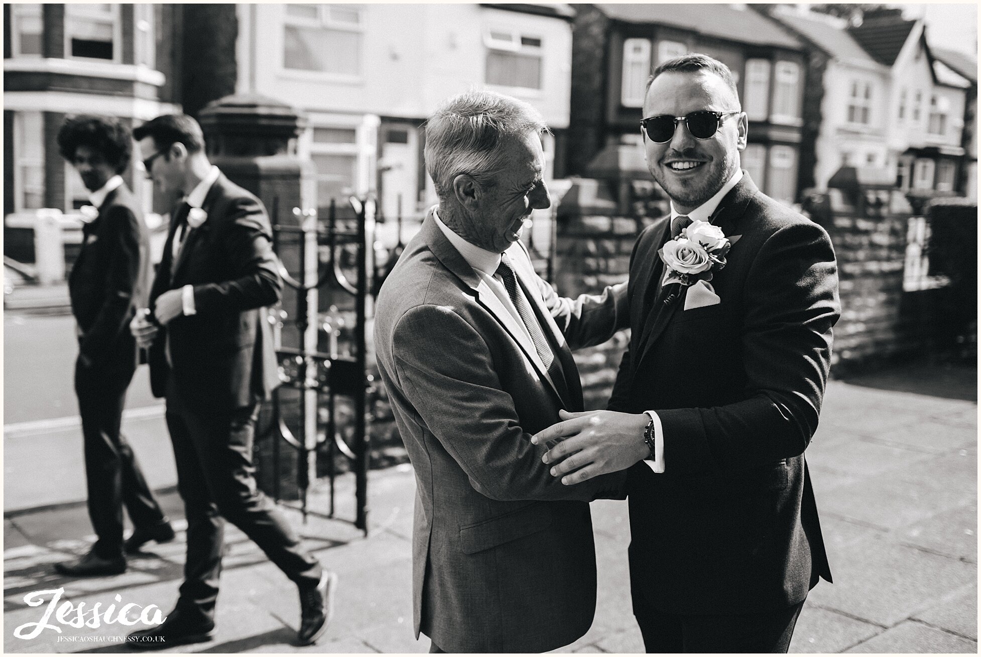 groom greets guests at the liverpool church