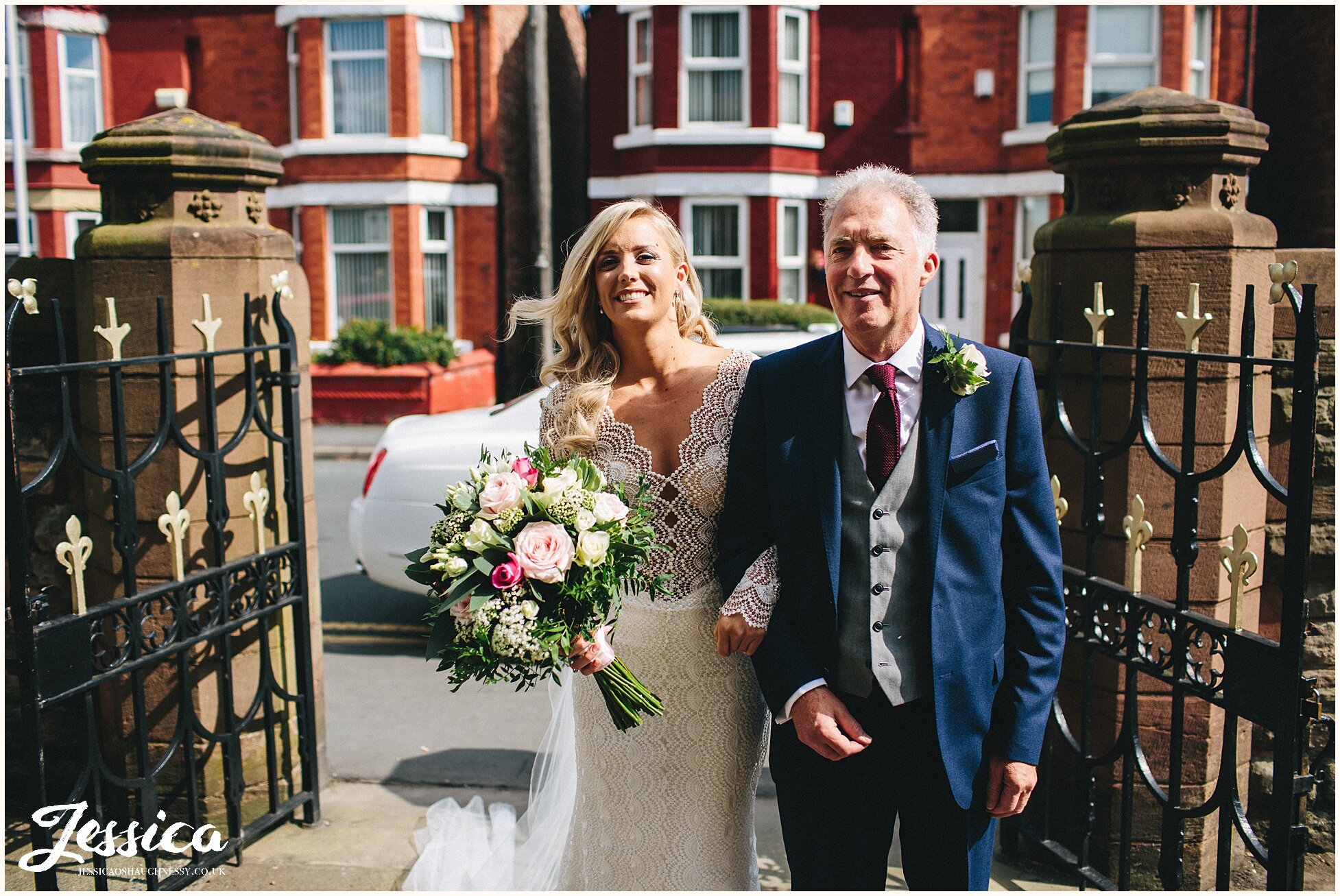 bride &amp; father walk into church for the wedding ceremony