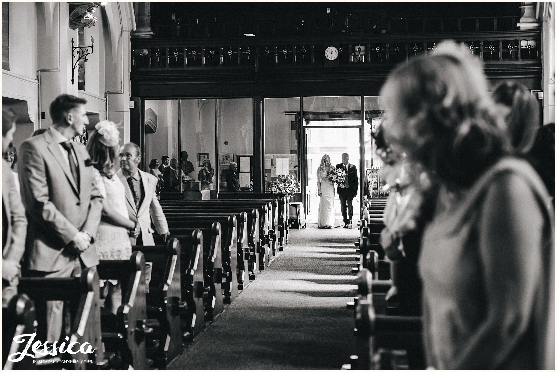 bride walks down the aisle of liverpool church