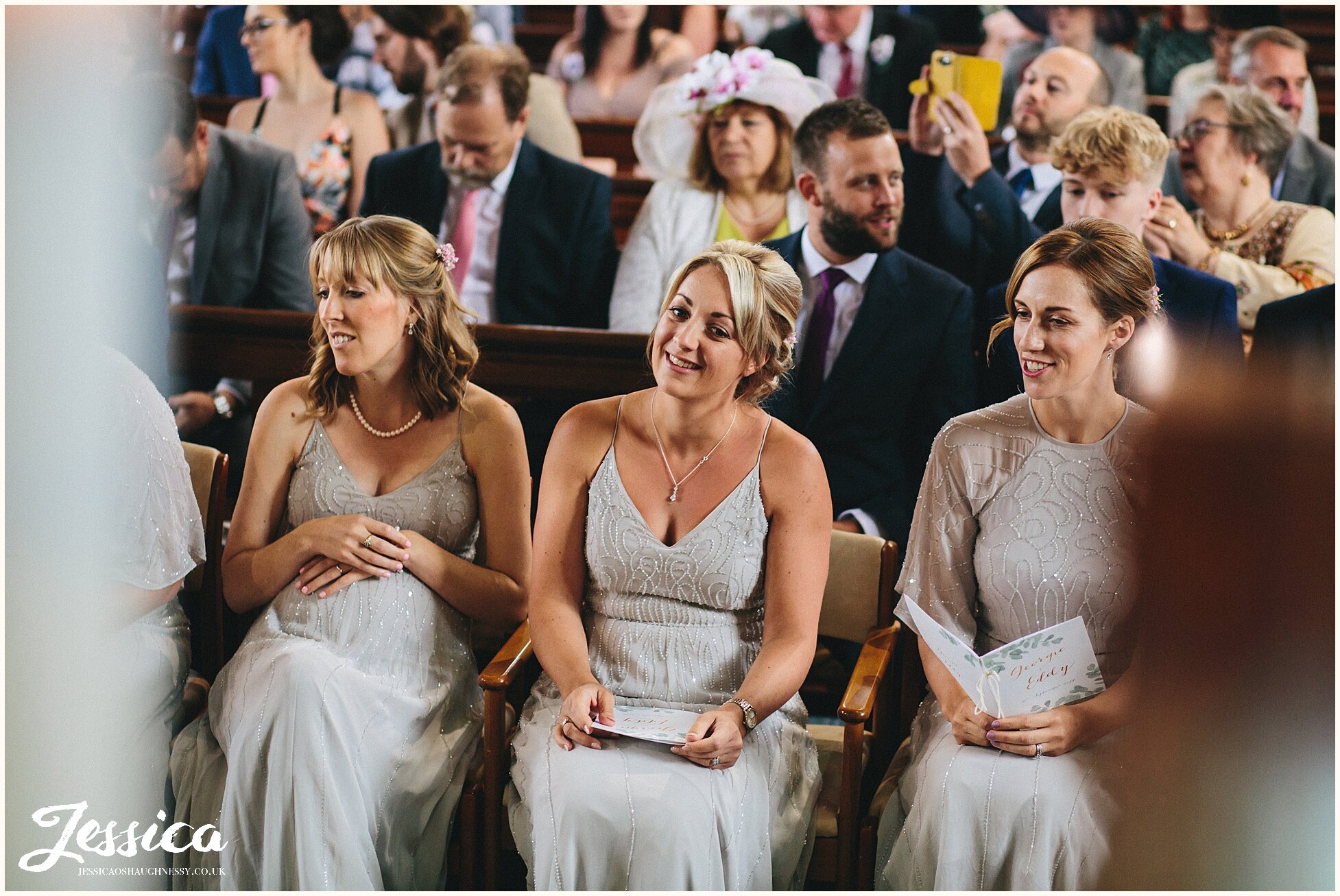 bridesmaids look emotional during the wedding ceremony