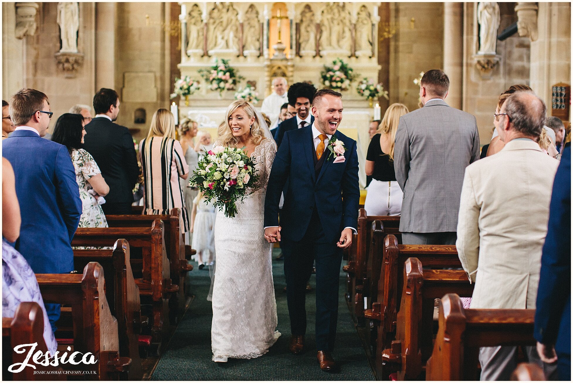newly wed's walk out of church as husband and wife