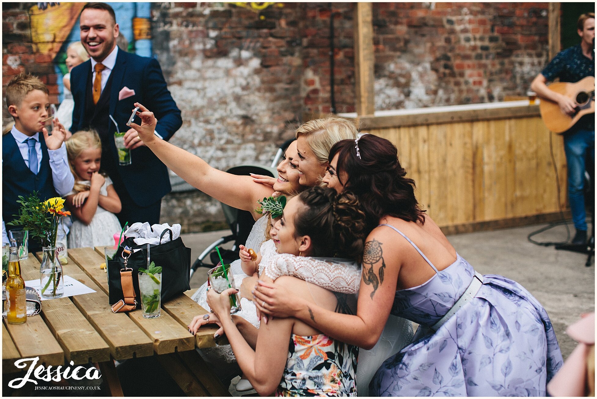 guests take a selfie with the bride at the baltic triangle wedding venue