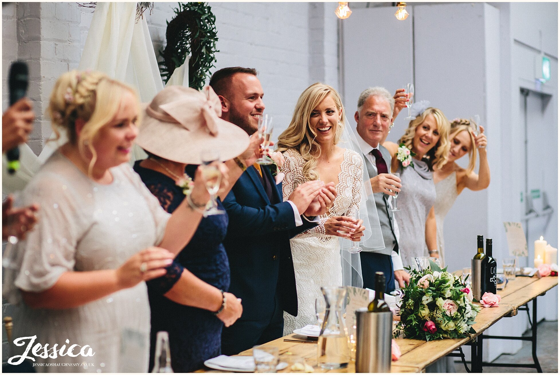 bride and groom clap after speeches end - liverpool wedding photographer