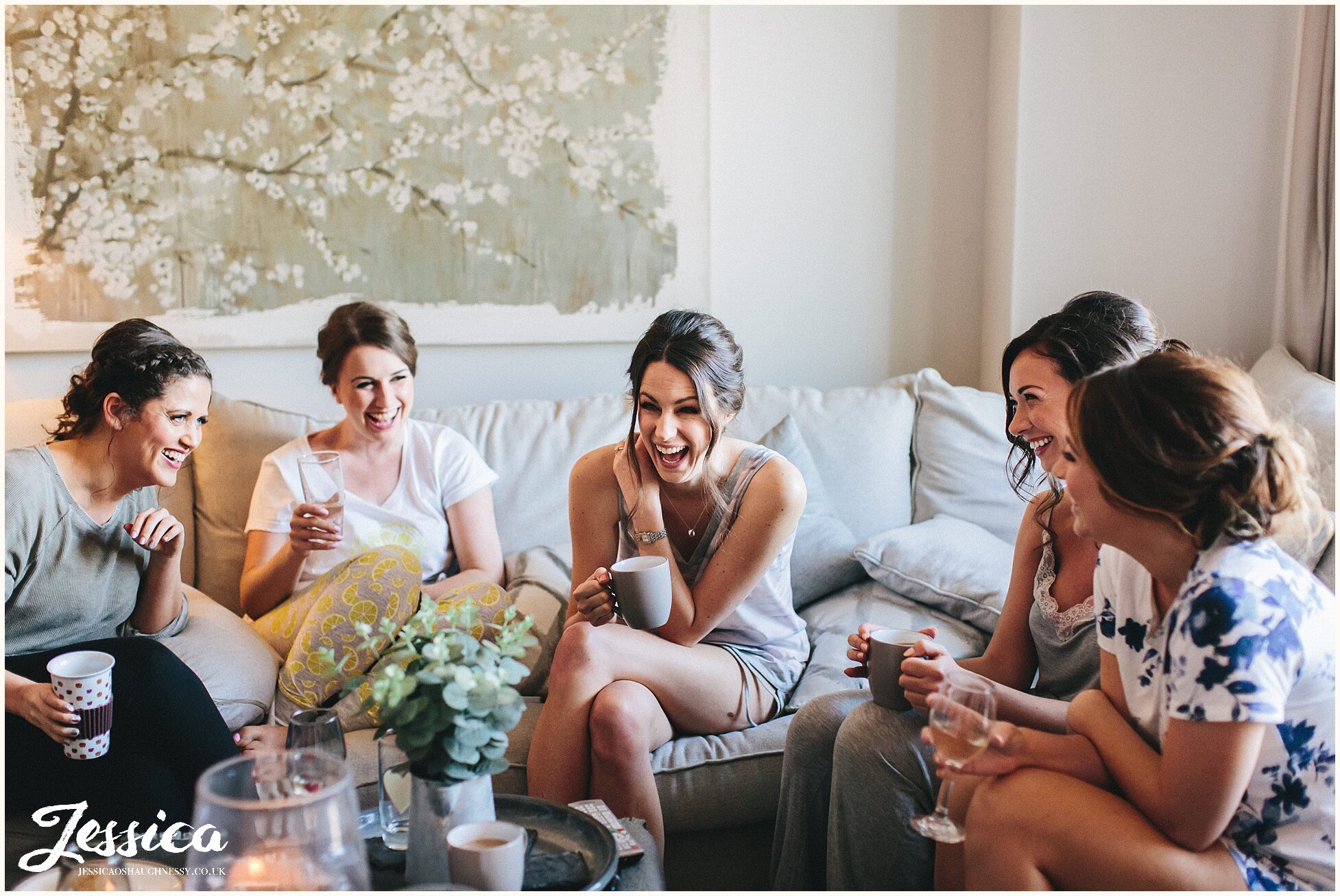bridesmaids laughing hysterically during bride prep